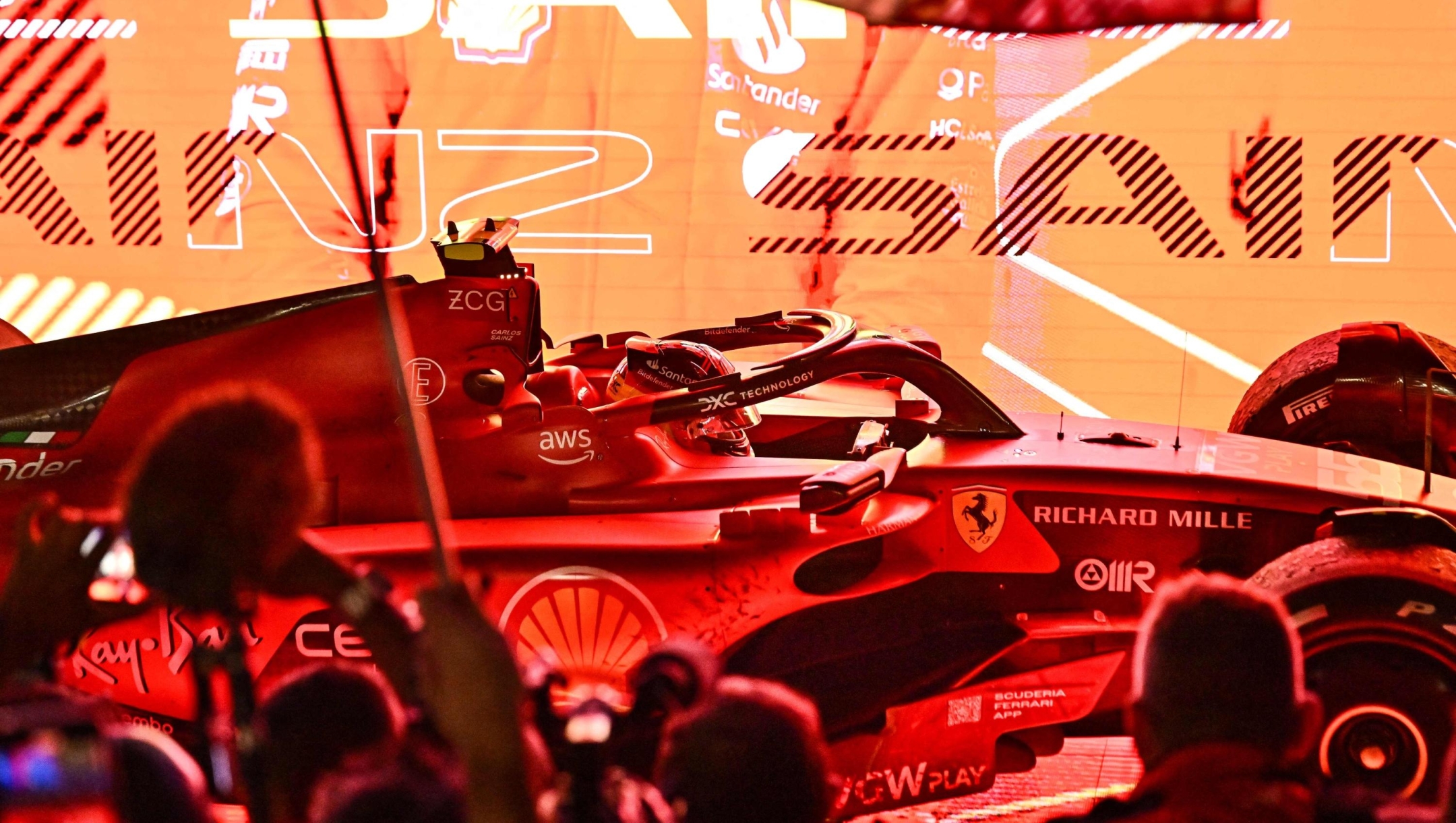 TOPSHOT - Ferrari's Spanish driver Carlos Sainz Jr arrives in his car after winning the Singapore Formula One Grand Prix night race at the Marina Bay Street Circuit in Singapore on September 17, 2023. (Photo by Lillian SUWANRUMPHA / AFP)