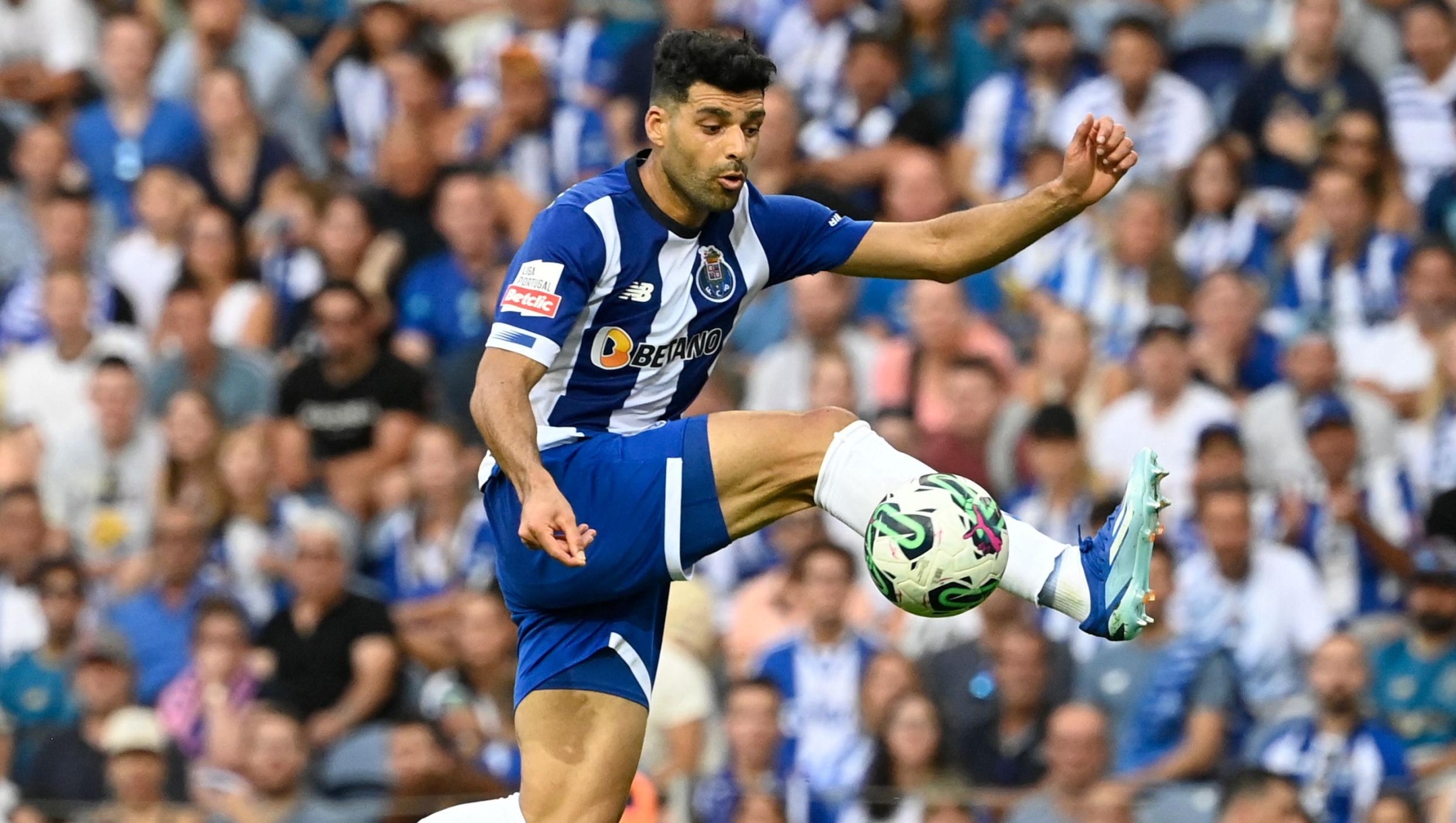 FC Porto's Iranian forward #09 Mehdi Taremi jumps for the ball during the Portuguese league football match between FC Porto and Portimonense SC at the Dragao stadium in Porto on October 8, 2023. (Photo by MIGUEL RIOPA / AFP)