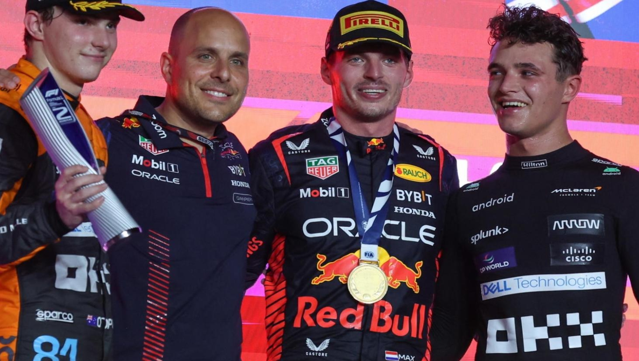 epa10908240 (L-R) Second placed Australian Formula One driver Oscar Piastri of McLaren F1 Team, an unidentifed Red Bull Racing team member, first placed Dutch Formula One driver Max Verstappen of Red Bull Racing, and third placed British Formula One driver Lando Norris of McLaren F1 Team celebrate on the podium after the Formula 1 Qatar Grand Prix in Lusail, Qatar, 08 October 2023.  EPA/ALI HAIDER