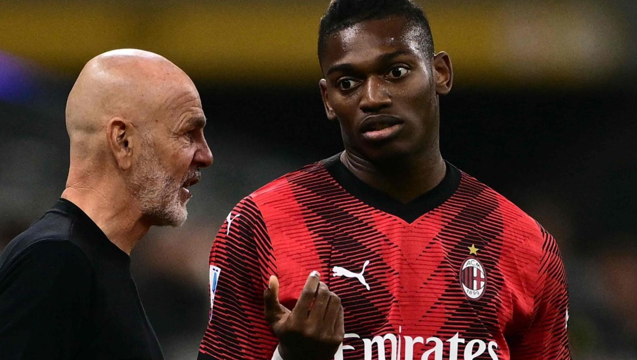 AC Milan's Portuguese forward #10 Rafael Leao listens to AC Milan's Italian coach Stefano Pioli during the Italian Serie A football match between Milan and Juventus at San Siro Stadium, in Milan on October 22, 2023. (Photo by Marco BERTORELLO / AFP)