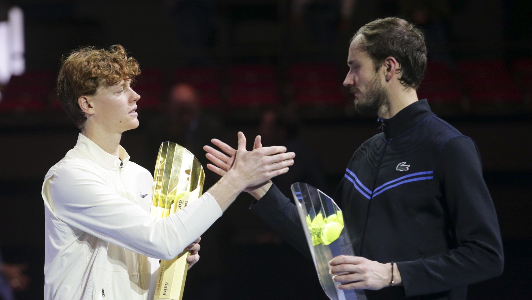 Jannik Sinner of Italy, left, celebrates with the trophy after winning the final match of the Erste Bank Open ATP tennis tournament against Daniil Medvedev of Russia, right, in Vienna, Austria, Sunday, Oct. 29, 2023. Sinner won 7-6 (7), 4-6, 6-3. (AP Photo/Heinz-Peter Bader)