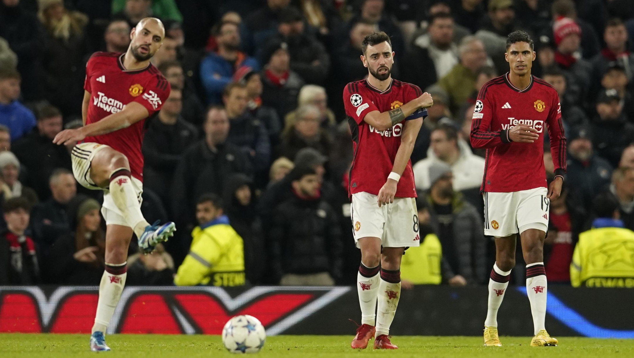 Manchester United players are dejected after Bayern's Kingsley Coman scored his side's opening goal during the group A Champions League soccer match between Manchester United and Bayern Munich at the Old Trafford stadium in Manchester, England, Tuesday, Dec. 12, 2023. (AP Photo/Dave Thompson)