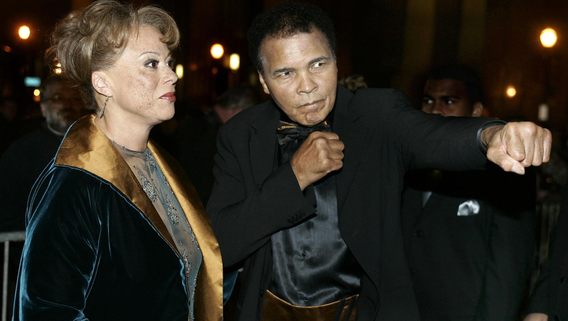 US boxing legend Muhammad Ali (R) strikes a boxing pose on the red carpet with his wife Lonnie, 19 November 2005, before the Grand Opening Gala for the Muhammad Ali Center at the Kentucky Center in Louisville, KY.  The Ali Center will open to the public, 21 November 2005, costing 80 million USD for the 93,000 square-foot six level center to be used as a "global gathering place" to promote peace and tolerance, and to inspire people to reach their potential.    AFP PHOTO/JEFF HAYNES