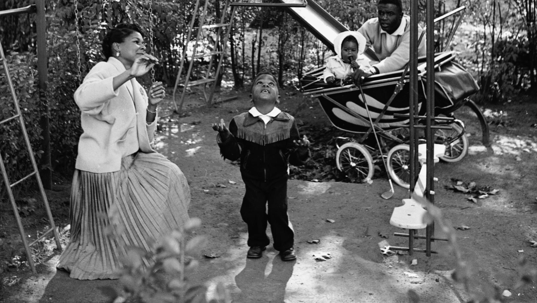 American baseball player Jackie Robinson and his wife Rachel play with son Jackie Jr. (L) and daughter Sharon  in the backyard of their home in Stamford, Connecticut, circa 1951.  (Photo by Hulton Archive/Getty Images)