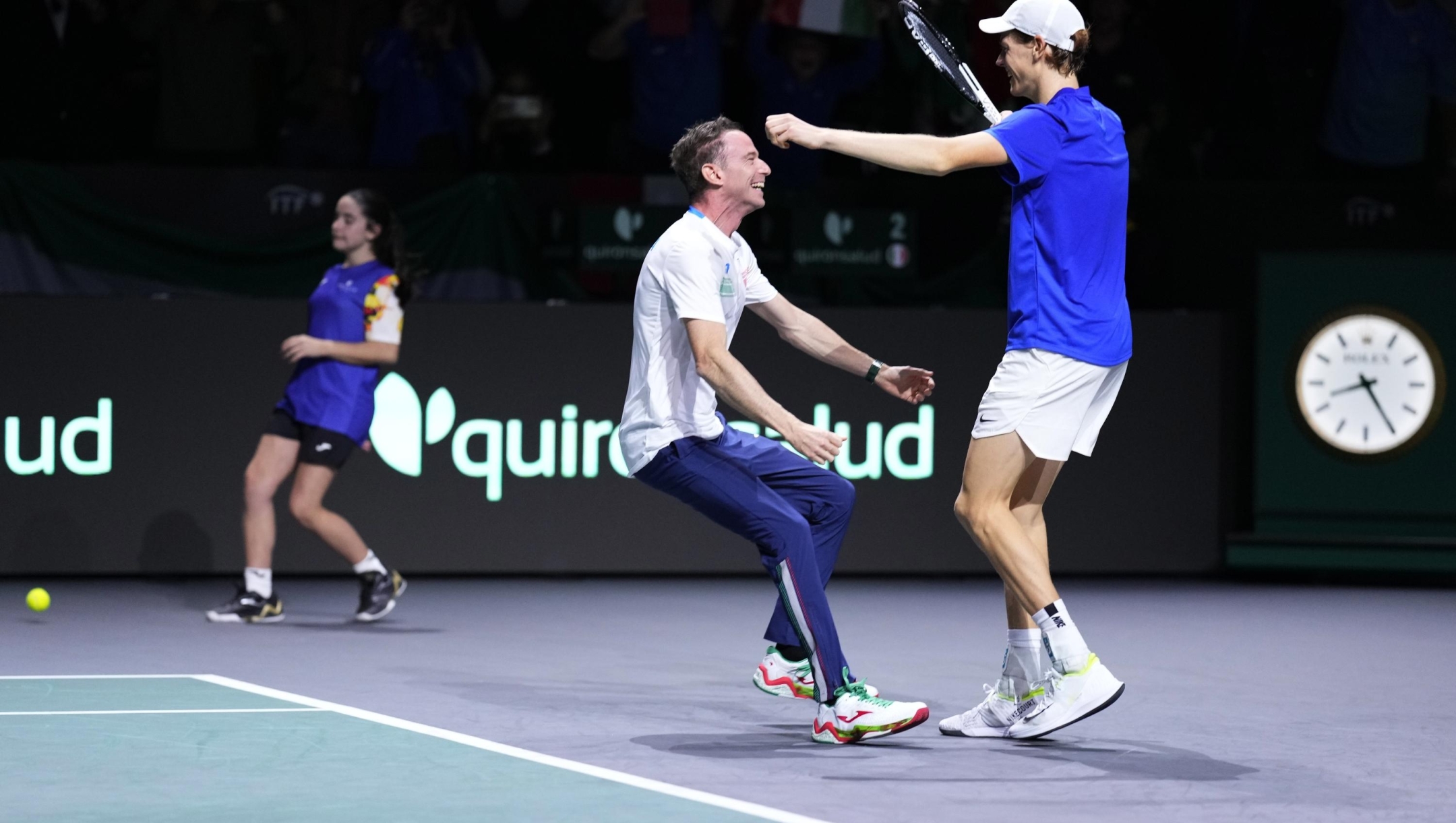 Italy's captain Filippo Volandri, centre, runs to embrace Jannik Sinner after he defeated Australia's Alex de Minaur in Match 2 during a Davis Cup final tennis match in Malaga, Spain, Sunday, Nov. 26, 2023. Italy are the 2023 World Champions Davis Cup winners. (AP Photo/Manu Fernandez)