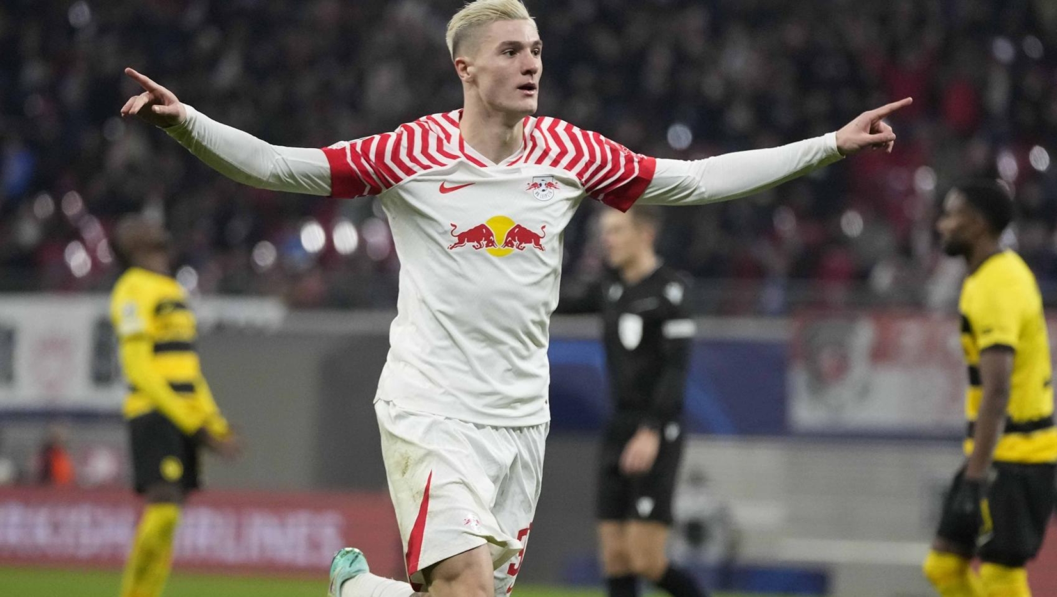 Leipzig's Benjamin Sesko celebrates after scoring his side's first goal during the group G Champions League soccer match between RB Leipzig and Young Boys Bern at the Red Bull arena stadium in Leipzig, Germany, Wednesday, Dec. 13, 2023. (AP Photo/Matthias Schrader)