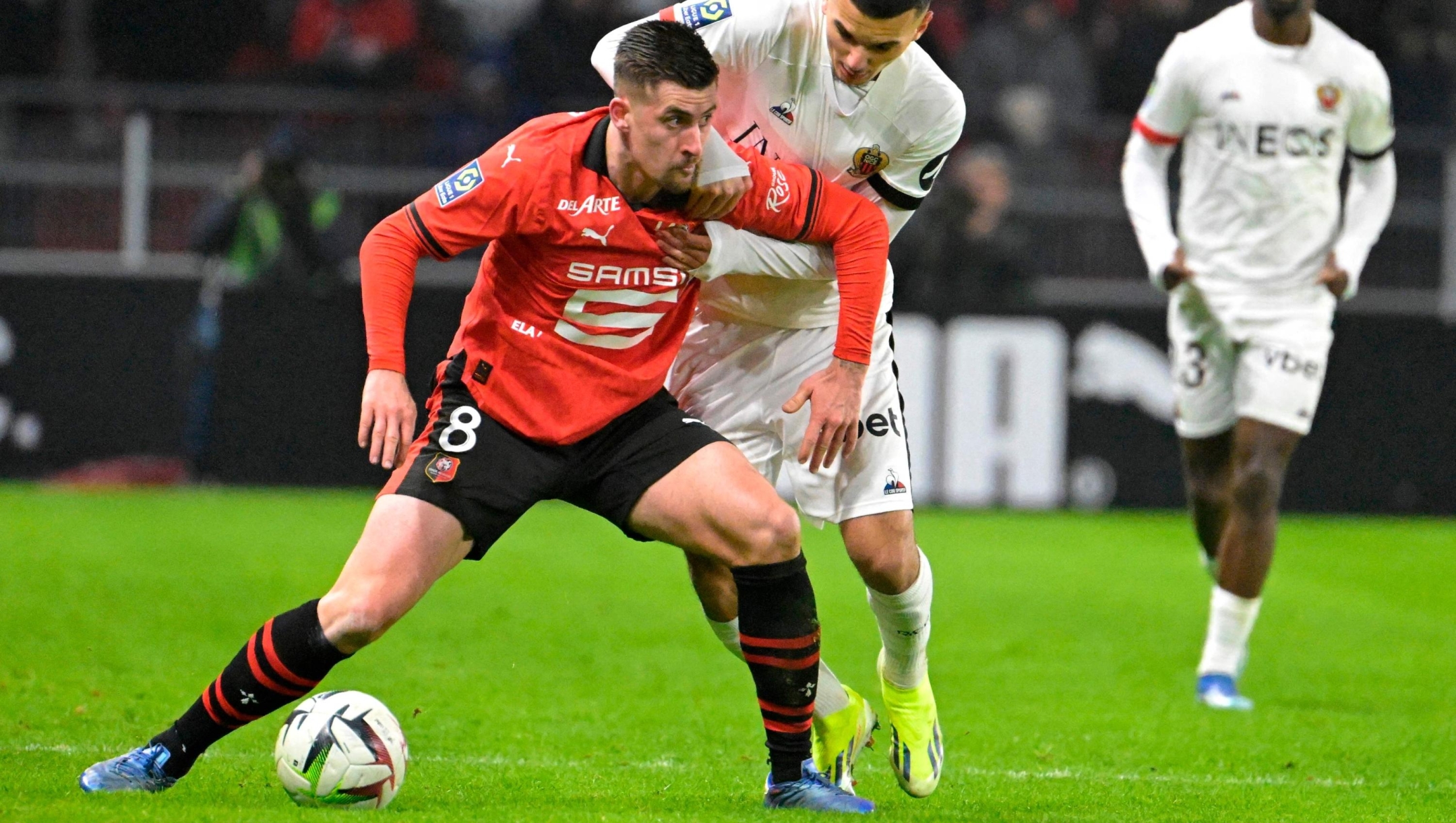 Rennes' French midfielder #08 Baptiste Santamaria (L) fights for the ball with Nice's French forward #22 Badredine Bouanani during the French L1 football match between Stade Rennais FC and OGC Nice at The Roazhon Park Stadium in Rennes, western France on January 13, 2024. (Photo by Damien Meyer / AFP)