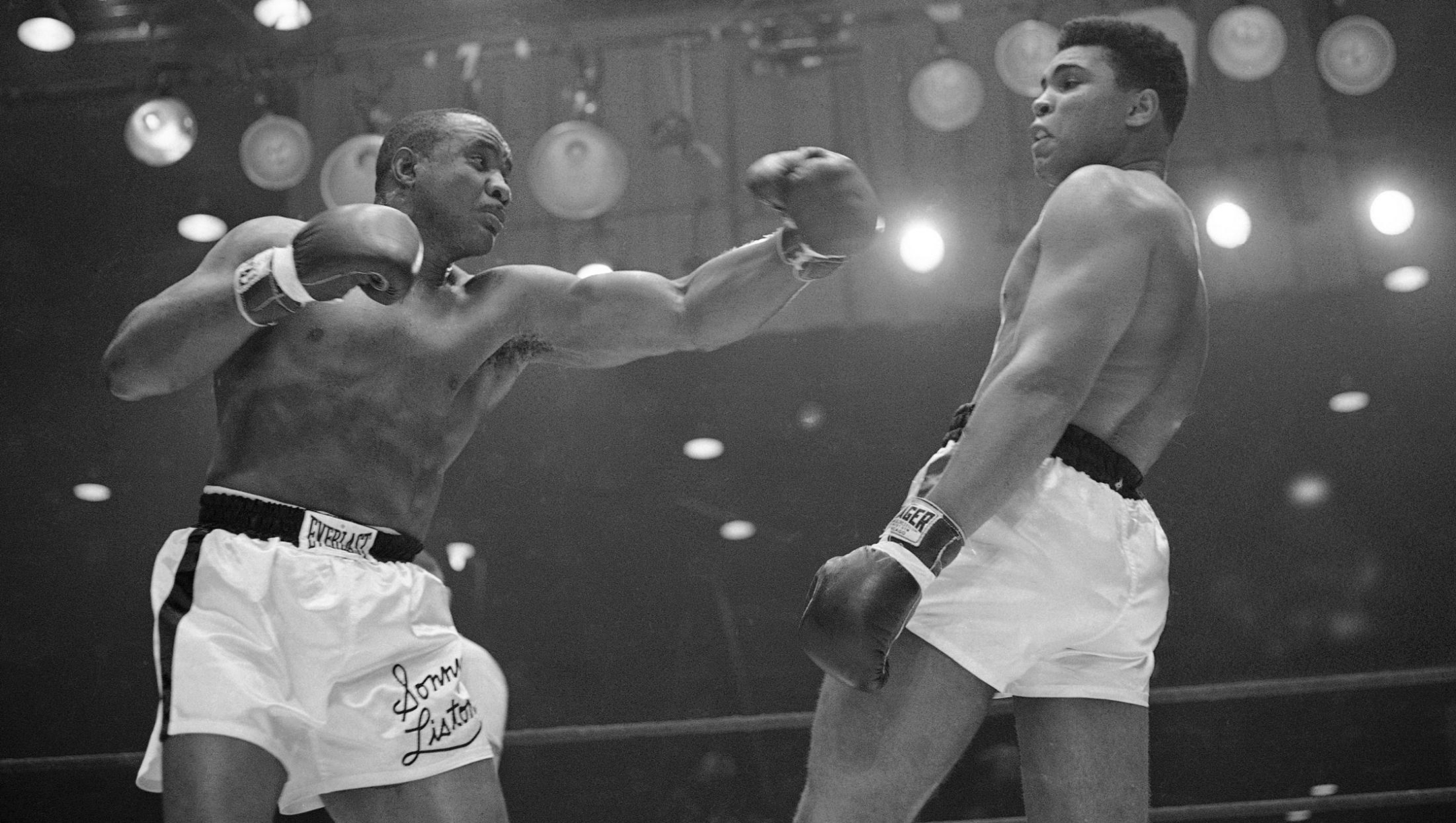 FILE - In this Feb. 26, 1964 file photo, Muhammad Ali (Cassius Clay)  uses a variety of bobbing and weaving to stay clear of the left arm of Sonny Liston in their title fight in Miami Beach, Fla.  Ali, the magnificent heavyweight champion whose fast fists and irrepressible personality transcended sports and captivated the world, has died according to a statement released by his family Friday, June 3, 2016. He was 74. (AP Photo)
