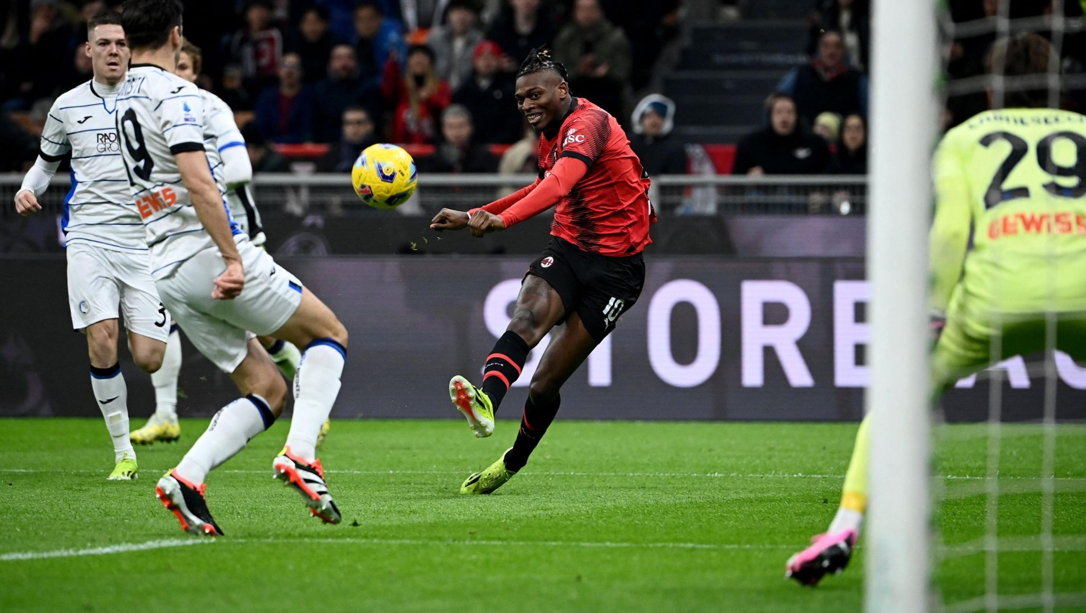 AC Milan's Portuguese forward #10 Rafael Leao (C) takes a shot to score a goal during the Italian Serie A football match between Milan AC and Atalanta at San Siro stadium in Milan on February 25, 2024. (Photo by Isabella BONOTTO / AFP)