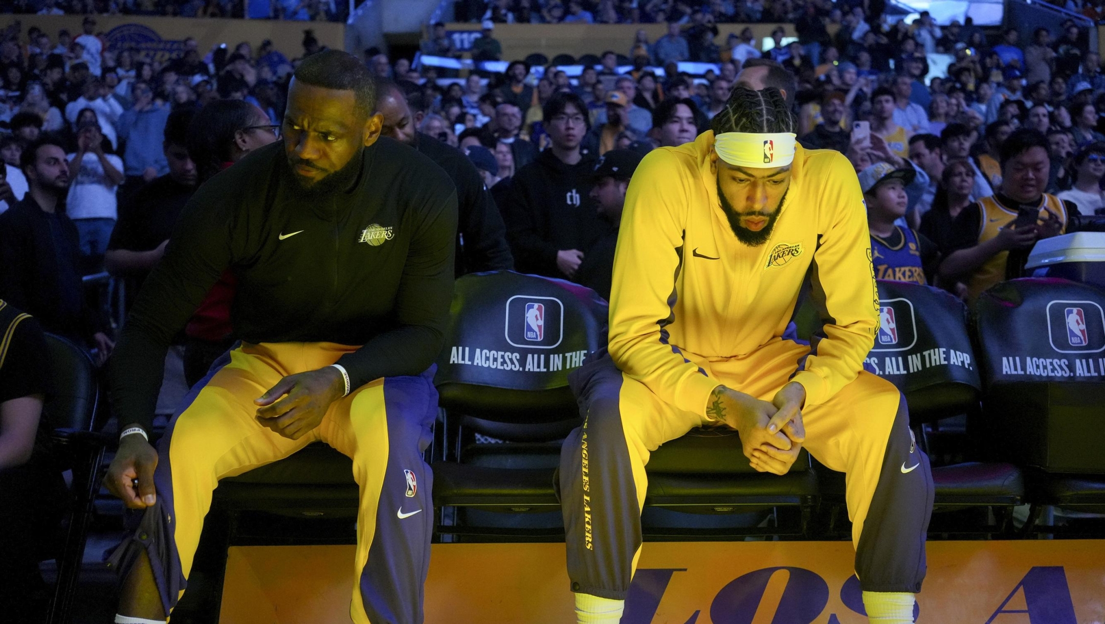 Los Angeles Lakers forwards LeBron James, left, and Anthony Davis, right, sit on the bench before an NBA basketball game against the Minnesota Timberwolves in Los Angeles, Sunday, March 10, 2024. (AP Photo/Eric Thayer)