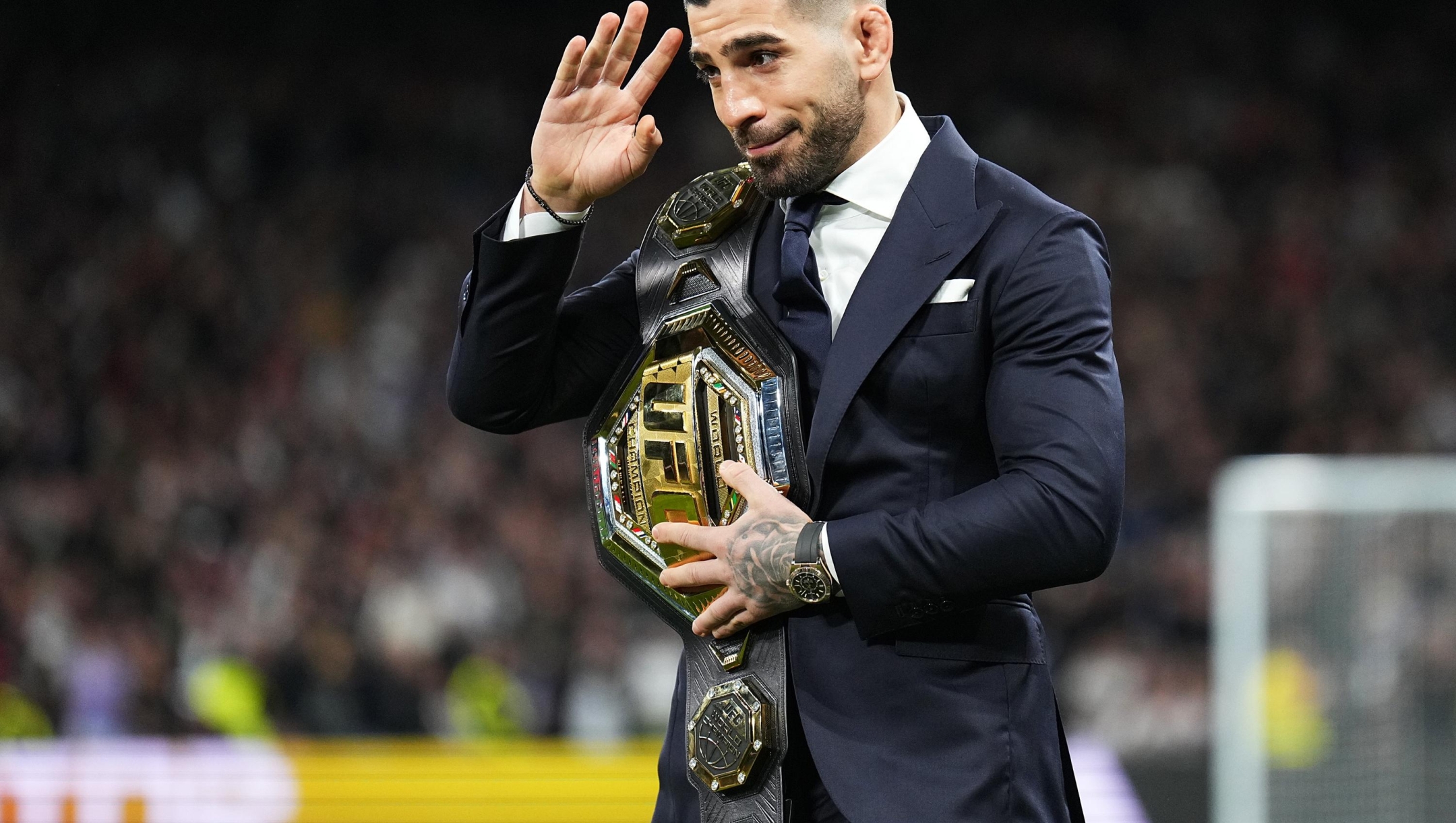 MADRID, SPAIN - FEBRUARY 25: Ilia Topuria, UFC Featherweight Champion, is seen with his belt on the pitch prior to the LaLiga EA Sports match between Real Madrid CF and Sevilla FC at Estadio Santiago Bernabeu on February 25, 2024 in Madrid, Spain. (Photo by Angel Martinez/Getty Images)