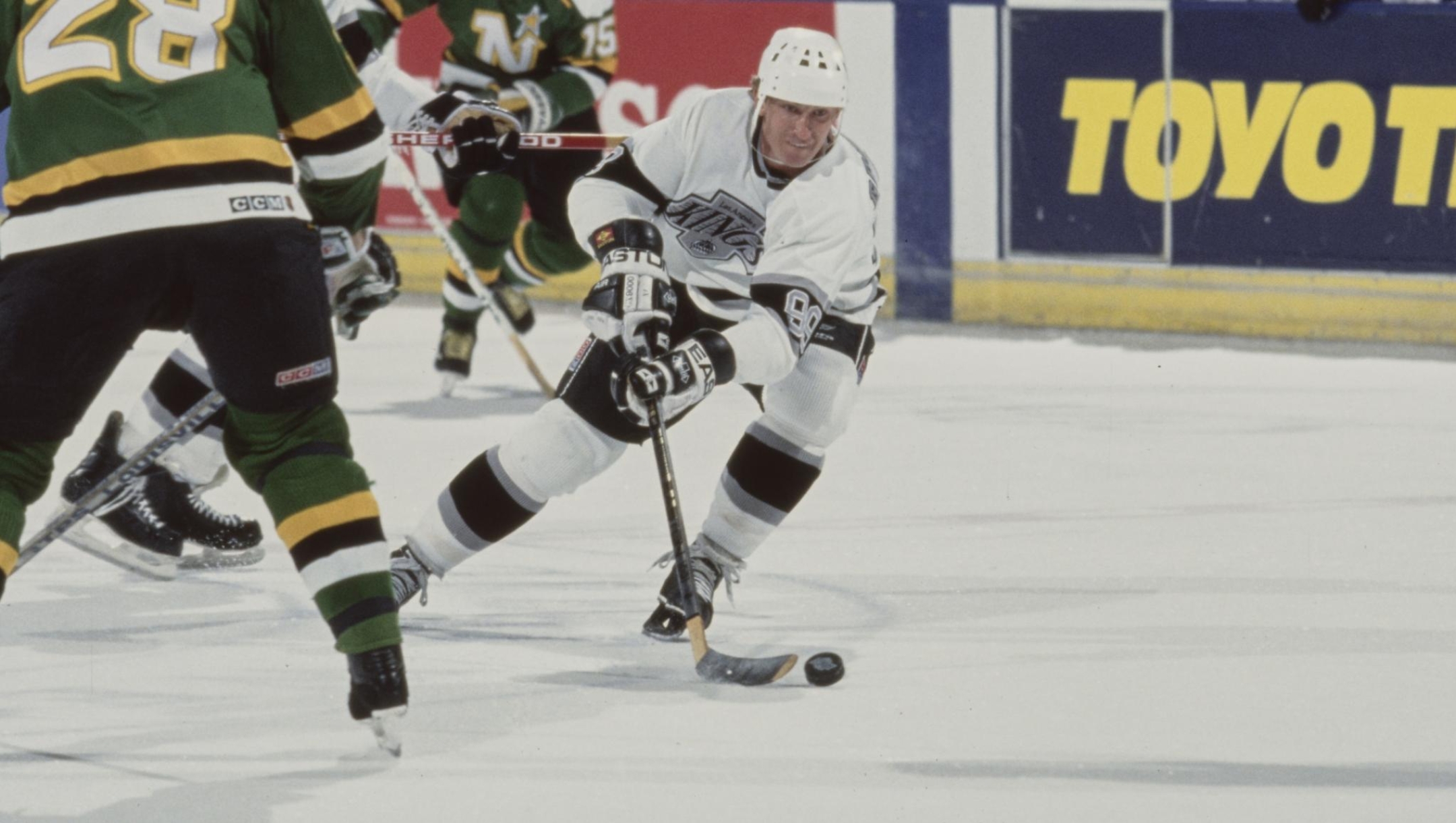 Wayne Gretzky #99, Captain and Center for the Los Angeles Kings in motion on the ice with hockey stick and puck during the NHL Western Conference Pacific Division game against the Minnesota North Stars on 17th October 1990 at the Great Western Forum arena in Inglewood, California, United States.  The Kings won the game 5 - 2  (Photo by Rick Stewart/Allsport/Getty Images)