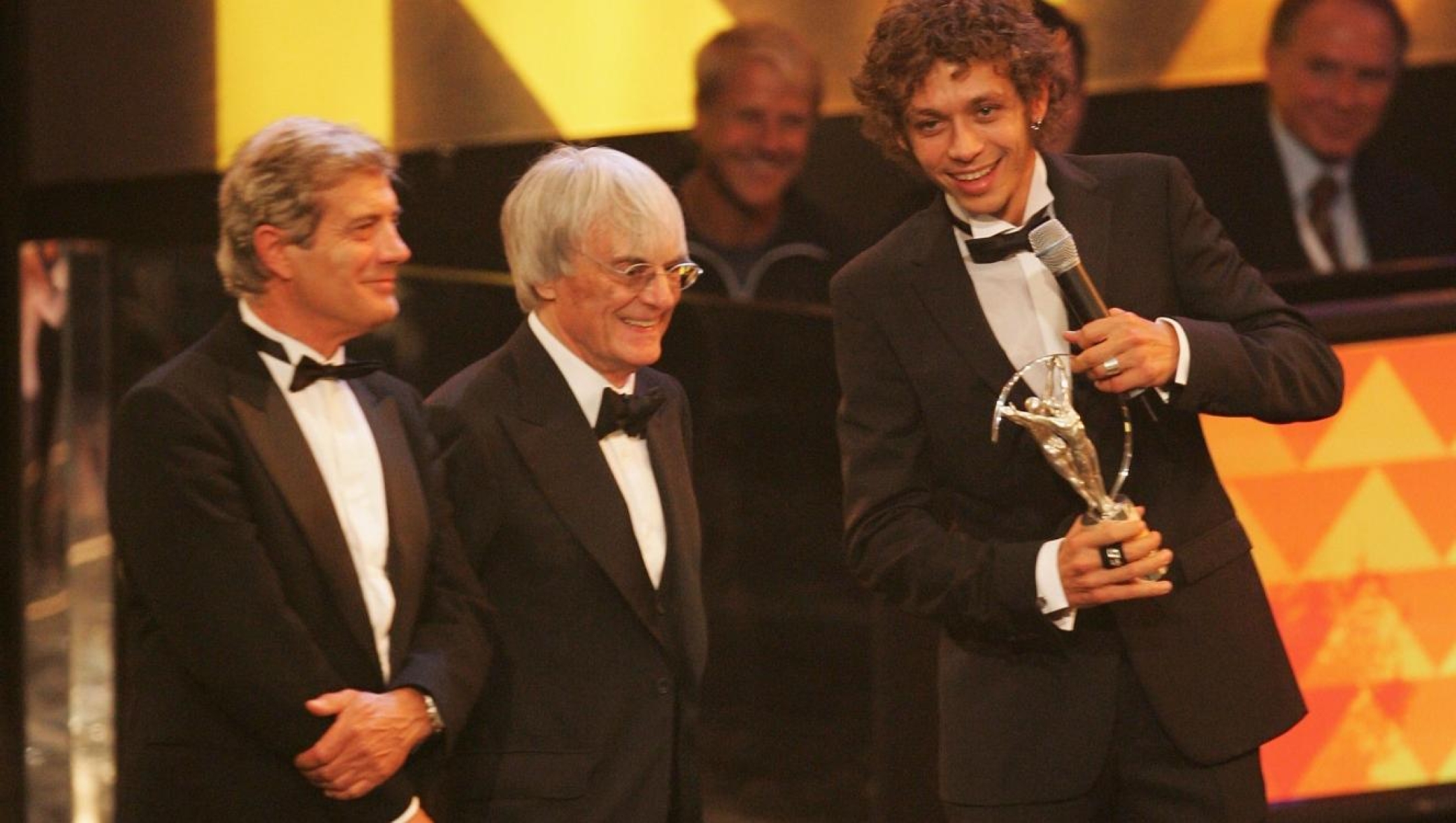 BARCELONA, SPAIN - MAY 22:  Academy member Giacomo Agostini (left), Bernie Ecclestone (centre) and Valentino Rossi during the Laureus World Sports Awards held at the Parc del Forum on May 22, 2006 in Barcelona, Spain.  (Photo by David Cannon/Getty Images for Laureus)