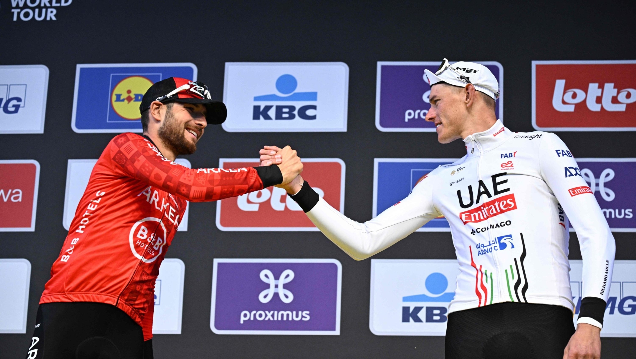 Winner Netherlands' Mathieu van der Poel of Alpecin-Deceuninck (R) and second-placed Italy's Luca Mozzato of Arkea-BB Hotels (L)  celebrate on the podium men's race of the 'Ronde van Vlaanderen' (Tour des Flandres) one day cycling race, 270,8 km from Antwerp to Oudenaarde, on March 31, 2024. (Photo by JASPER JACOBS / Belga / AFP) / Belgium OUT