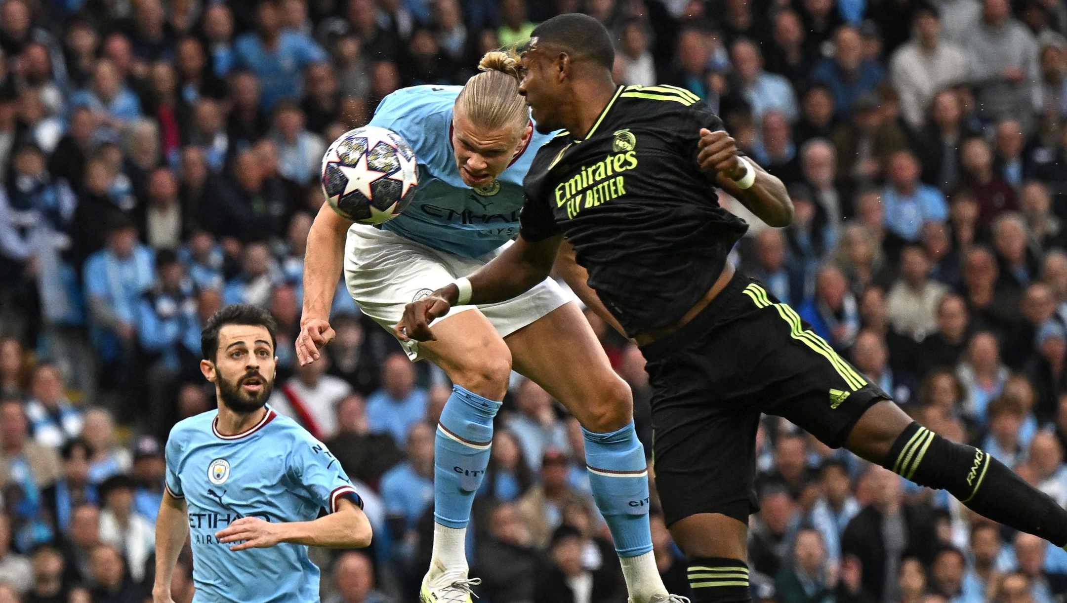 Manchester City's Norwegian striker Erling Haaland (C) headers toward goal but has his shot saved during the UEFA Champions League second leg semi-final football match between Manchester City and Real Madrid at the Etihad Stadium in Manchester, north west England, on May 17, 2023. (Photo by Paul ELLIS / AFP)