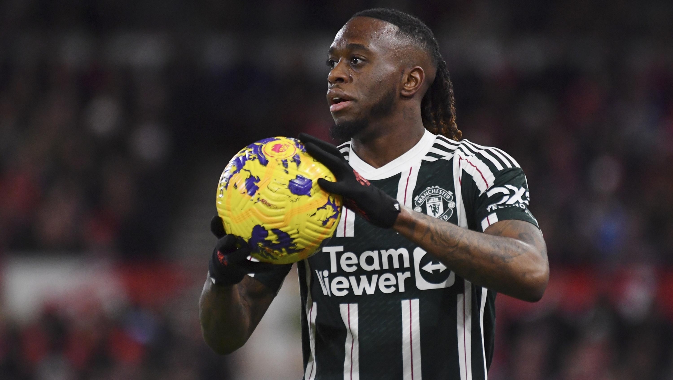 Manchester United's Aaron Wan-Bissaka holds the ball during the English Premier League soccer match between Nottingham Forest and Manchester United at City Ground in Nottingham, England, Saturday, Dec. 30, 2023. (AP Photo/Rui Vieira)