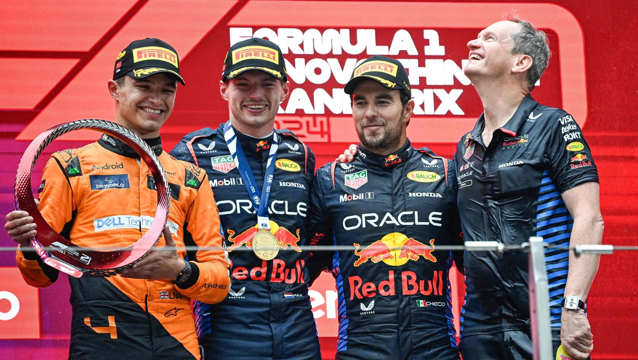 Winner Red Bull Racing's Dutch driver Max Verstappen (2nd L) celebrates on the podium with second-placed McLaren's British driver Lando Norris (L) and third-placed Red Bull Racing's Mexican driver Sergio Perez (2nd R) after the Formula One Chinese Grand Prix at the Shanghai International Circuit in Shanghai on April 21, 2024. (Photo by PEDRO PARDO / AFP)