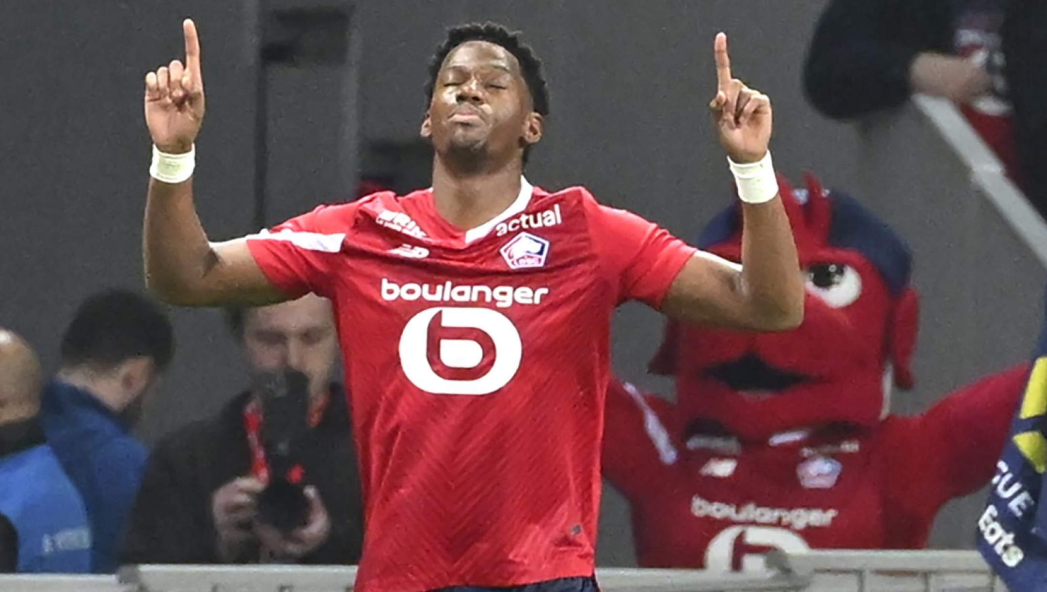 Lille's Jonathan David celebrates after scoring his side's opening goal during the French League One soccer match between Lille and Marseille at the Pierre Mauroy stadium in Villeneuve d'Ascq, northern France, Friday, April 5, 2024. (AP Photo/Matthieu Mirville)