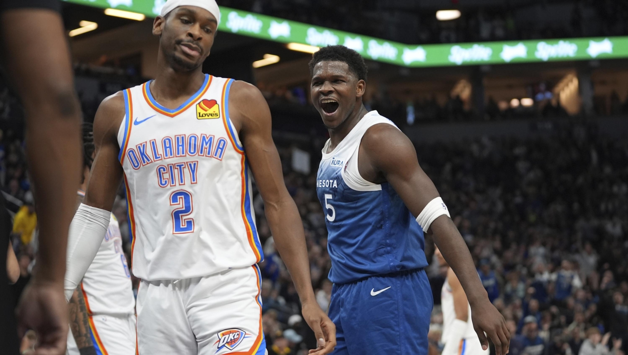 Minnesota Timberwolves guard Anthony Edwards (5) celebrates next to Oklahoma City Thunder guard Shai Gilgeous-Alexander (2) after making a basket and being fouled during the first half of an NBA basketball game Saturday, Jan. 20, 2024, in Minneapolis. (AP Photo/Abbie Parr)