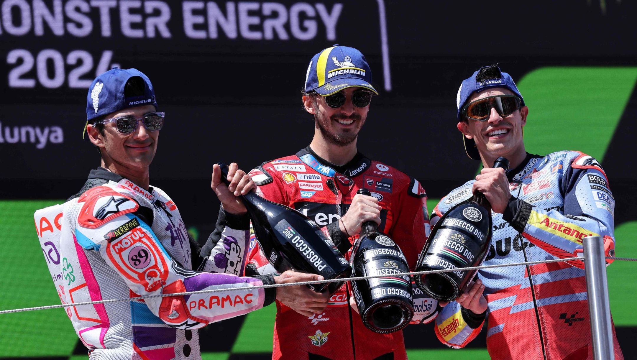 (From L) Second-placed Ducati Spanish rider Jorge Martin, winner Ducati Italian rider Francesco Bagnaia and third-placed Ducati Spanish rider Marc Marquez celebrate on the podium after the MotoGP Race of the Moto Grand Prix of Catalonia at the Circuit de Catalunya on May 26, 2024 in Montmelo on the outskirts of Barcelona. (Photo by LLUIS GENE / AFP)