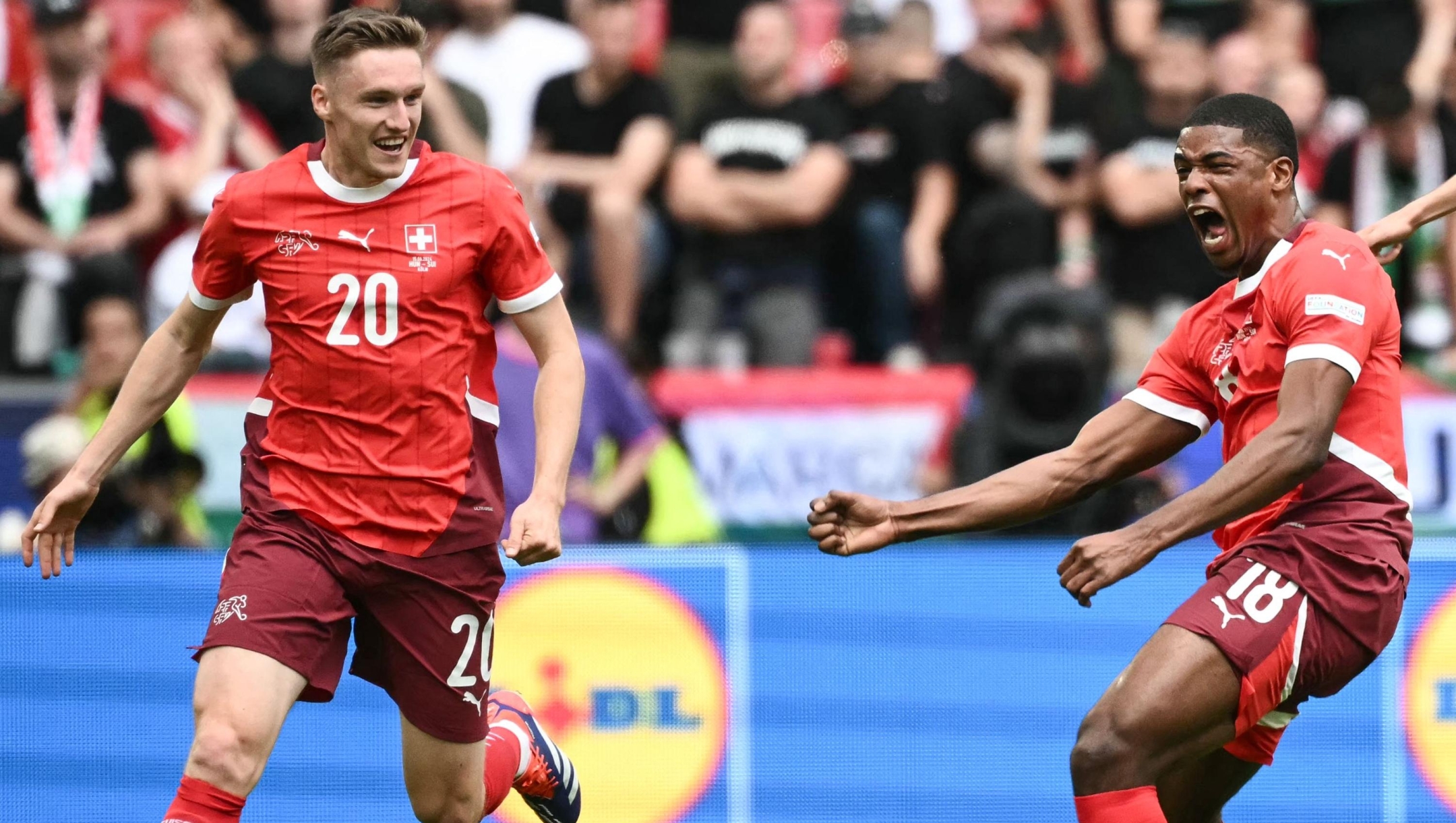 Switzerland's forward #18 Kwadwo Duah celebrates scoring the opening goal with his teammate Switzerland's midfielder #20 Michel Aebischer during the UEFA Euro 2024 Group A football match between Hungary and Switzerland at the Cologne Stadium in Cologne on June 15, 2024. (Photo by Angelos Tzortzinis / AFP)