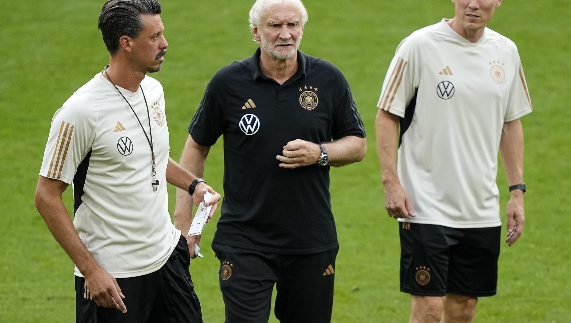 FILE - Germany's then interim coaches Rudi Voeller, center, Hannes Wolf, right, and Sandro Wagner, left, lead the last training session ahead of an international friendly soccer match between Germany and France in Dortmund, Germany, Monday, Sept. 11, 2023. Rudi Völler is set to stay on as sporting director of the German men’s national soccer team through to the 2026 World Cup. (AP Photo/Martin Meissner, File)