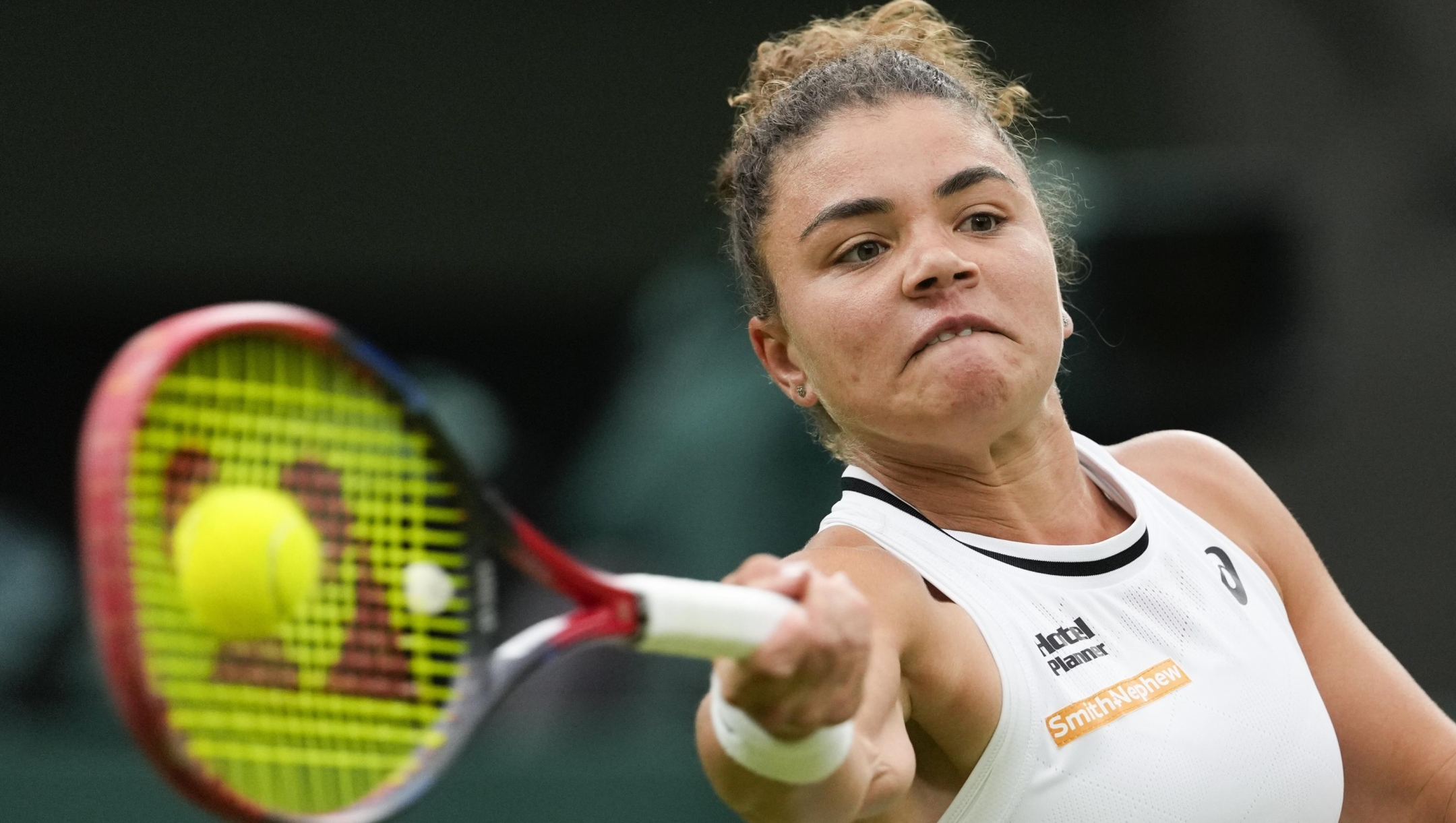Jasmine Paolini of Italy plays a forehand return to Emma Navarro of the United States during their quarterfinal match at the Wimbledon tennis championships in London, Tuesday, July 9, 2024. (AP Photo/Alberto Pezzali)