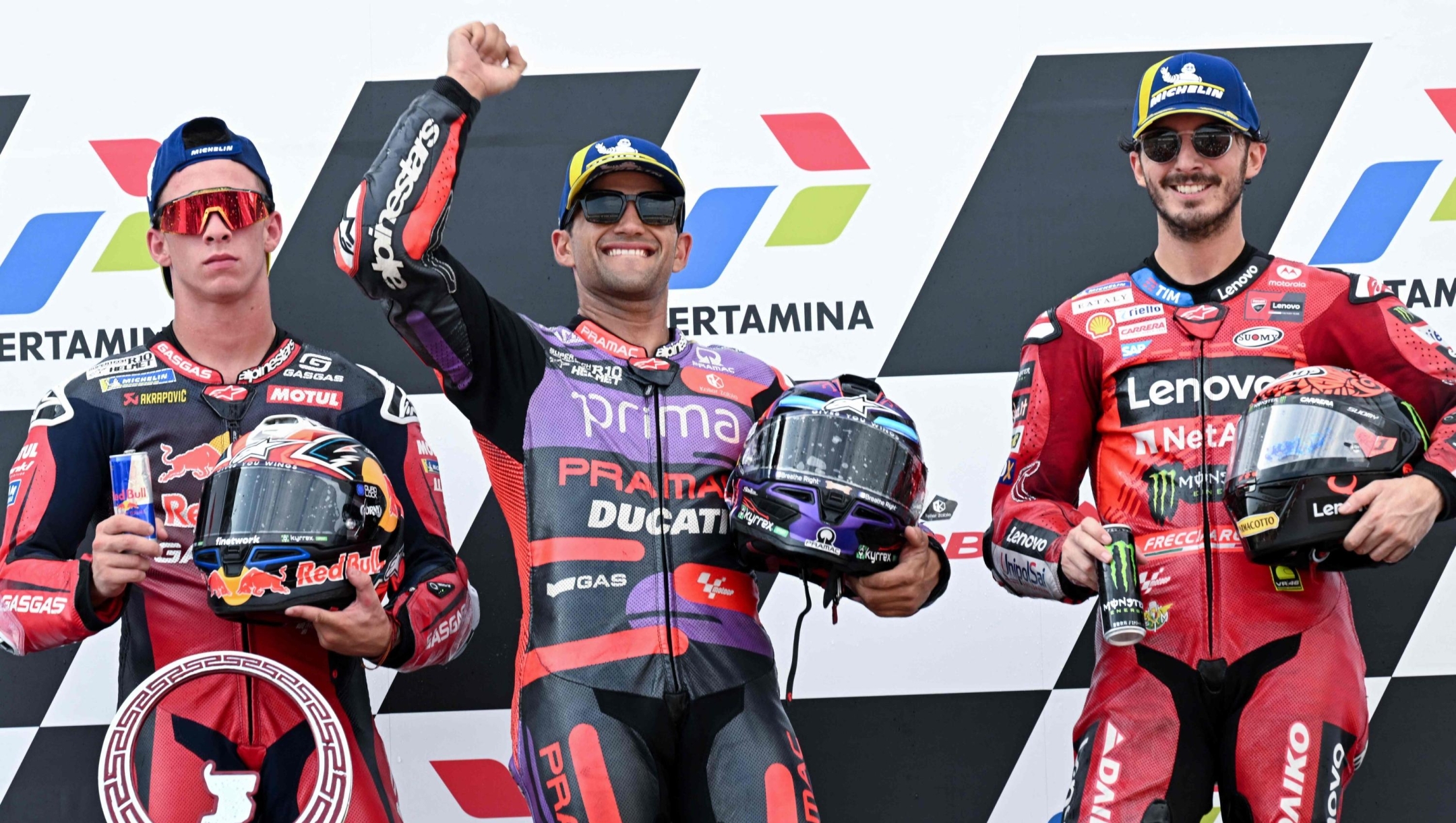 (L to R) Second-placed RedBull GASGAS Tech3's Spanish rider Pedro Acosta, first-placed Prima Pramac Racing's Spanish rider Jorge Martin and third-placed Ducati Lenovo Team's Italian rider Francesco Bagnaia celebrate on the podium following the MotoGP race of the Indonesian Grand Prix at the Mandalika International Circuit in Mandalika, West Nusa Tenggara on September 29, 2024. (Photo by SONNY TUMBELAKA / AFP)