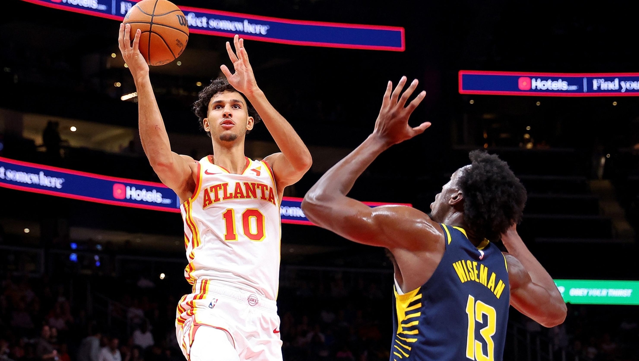 ATLANTA, GEORGIA - OCTOBER 08: Zaccharie Risacher #10 of the Atlanta Hawks drives against James Wiseman #13 of the Indiana Pacers during the first quarter at State Farm Arena on October 08, 2024 in Atlanta, Georgia. NOTE TO USER: User expressly acknowledges and agrees that, by downloading and/or using this photograph, user is consenting to the terms and conditions of the Getty Images License Agreement.   Kevin C. Cox/Getty Images/AFP (Photo by Kevin C. Cox / GETTY IMAGES NORTH AMERICA / Getty Images via AFP)