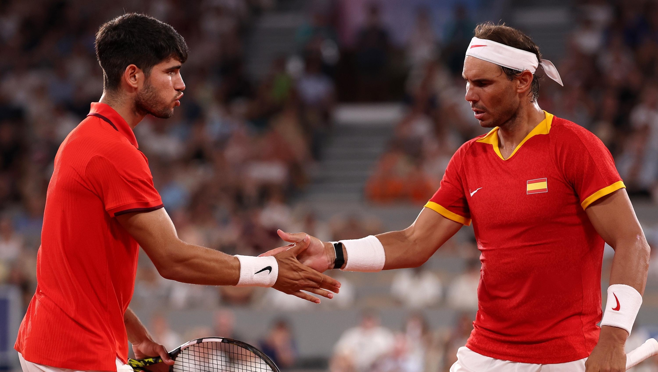 PARIS, FRANCE - JULY 31: Rafael Nadal of Team Spain (R) and Carlos Alcaraz of Team Spain interact against Austin Krajicek of Team United States and Rajeev Ram of Team United States during the Men's Doubles Quarter-final match on day five of the Olympic Games Paris 2024 at Roland Garros on July 31, 2024 in Paris, France. (Photo by Julian Finney/Getty Images)