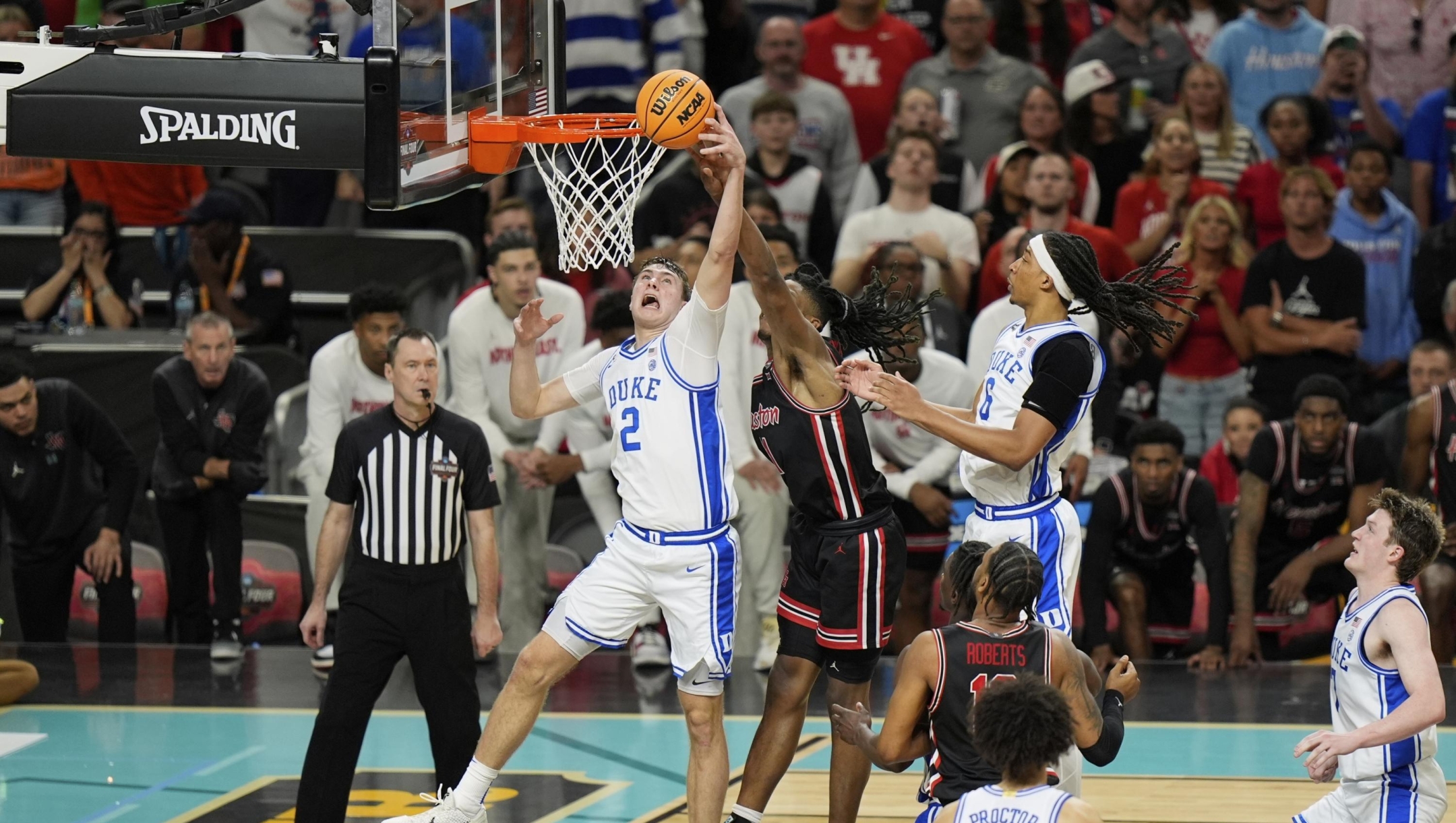 Duke's Cooper Flagg (2) shoots as Houston's Joseph Tugler (11) defends during the second half in the national semifinals at the Final Four of the NCAA college basketball tournament, Saturday, April 5, 2025, in San Antonio. (AP Photo/Stephanie Scarbrough)