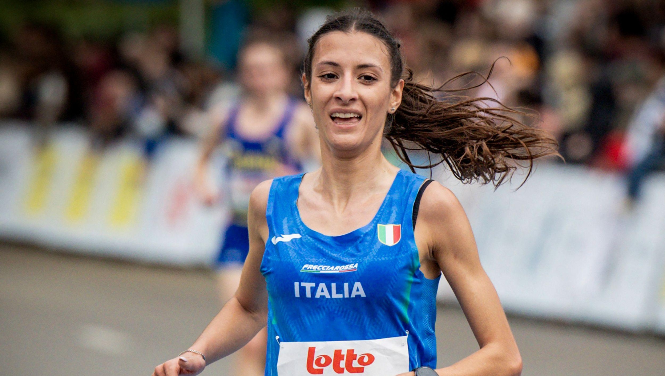 Italy's Nadia Battocletti celebrates as she crosses the finish line to win the women's 10km race during the European Running Championships, in Leuven, on April 13, 2025. (Photo by DAVID PINTENS / Belga / AFP) / Belgium OUT