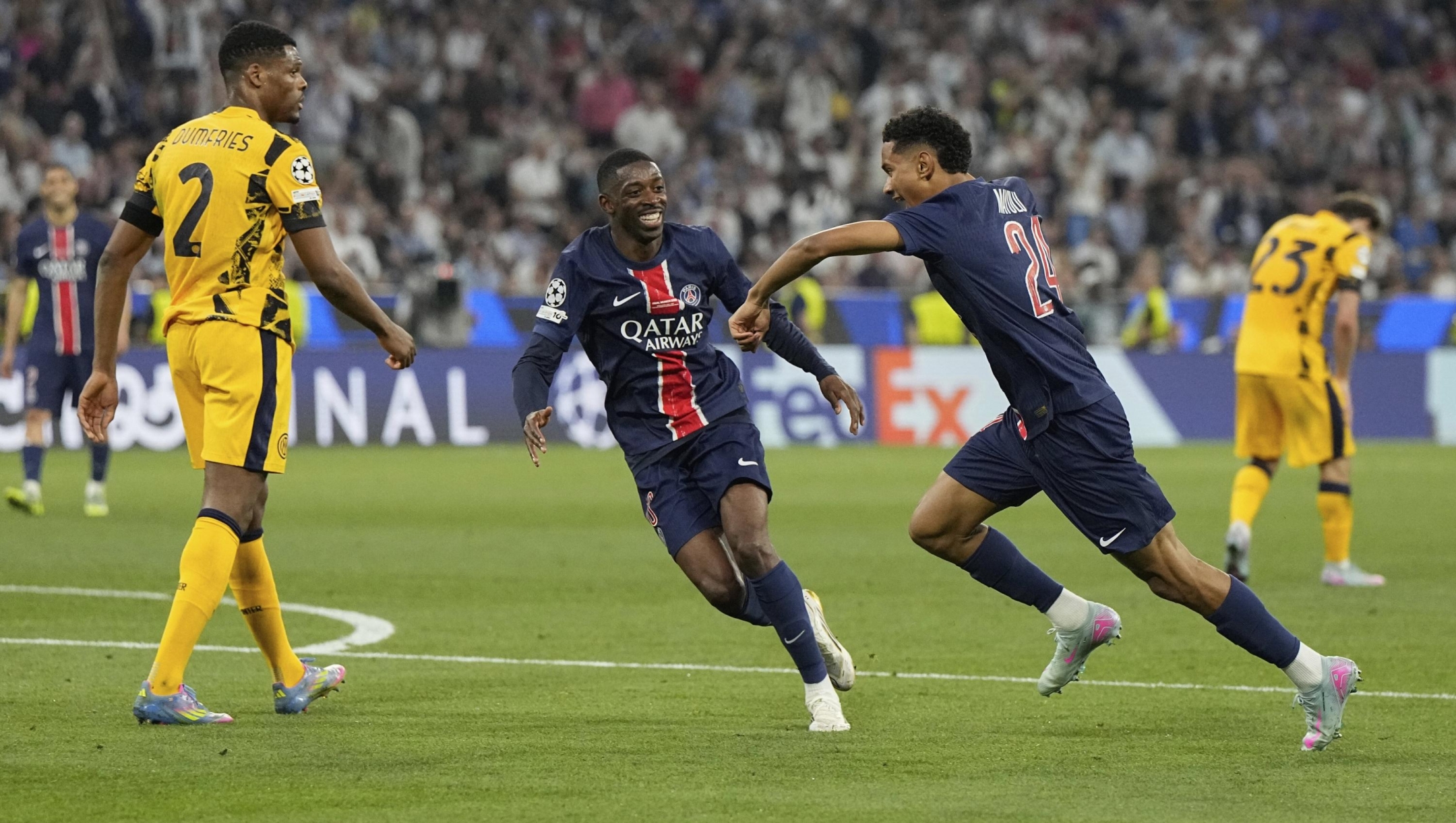 PSG's Senny Mayulu, right, celebrates after scoring his side's fifth goal during the Champions League final soccer match between Paris Saint-Germain and Inter Milan at the Allianz Arena in Munich, Germany, Saturday, May 31, 2025. (AP Photo/Martin Meissner)