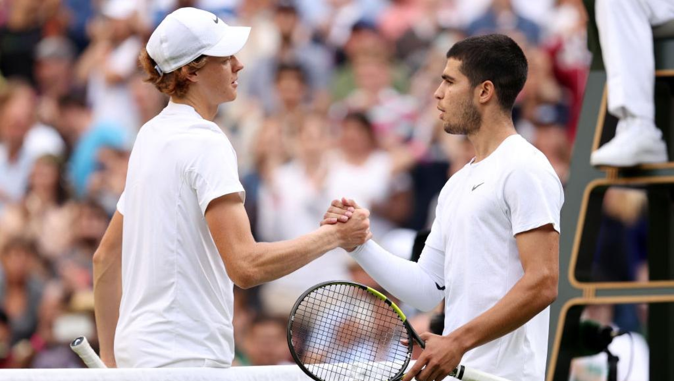 Jannik Sinner of Italy and Carlos Alcaraz of Spain interact following their Men's Singles Fourth Round match on day seven of The Championships Wimbledon 2022 at All England Lawn Tennis and Croquet Club on July 03, 2022 in London, England. (Photo by Ryan Pierse/Getty Images)