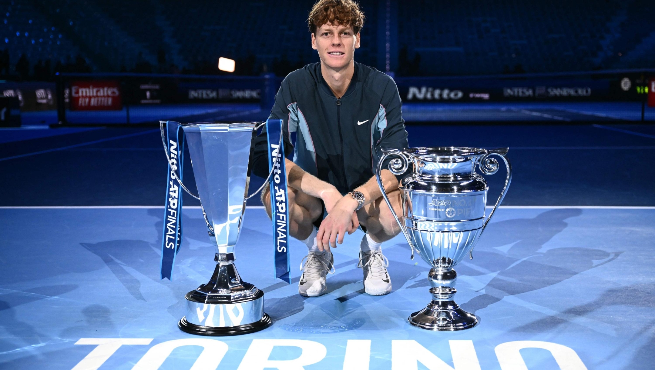 Italy's Jannik Sinner poses with the trophy of the tournament and the ATP year-end No.1 trophy, after winning the final against USA's Taylor Fritz at the ATP Finals tennis tournament in Turin on November 17, 2024. (Photo by Marco BERTORELLO / AFP)