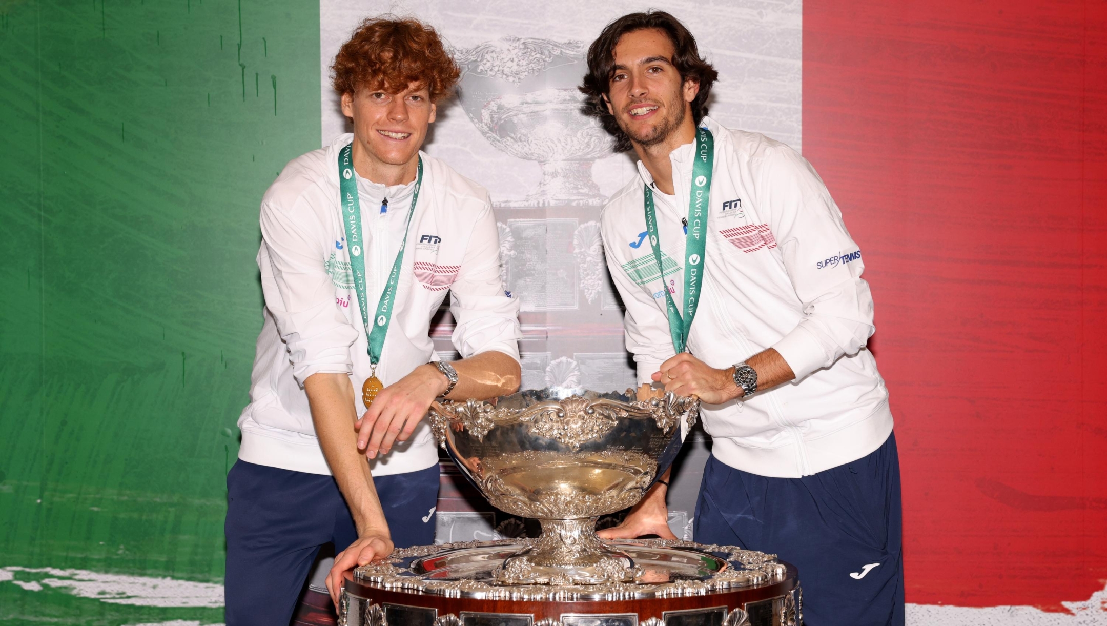 Jannik Sinner and Lorenzo Musetti of Italy celebrate with the Davis Cup Trophy after their teams victory during the Davis Cup Final match against Australia at Palacio de Deportes Jose Maria Martin Carpena on November 26, 2023 in Malaga, Spain. (Photo by Clive Brunskill/Getty Images for ITF)