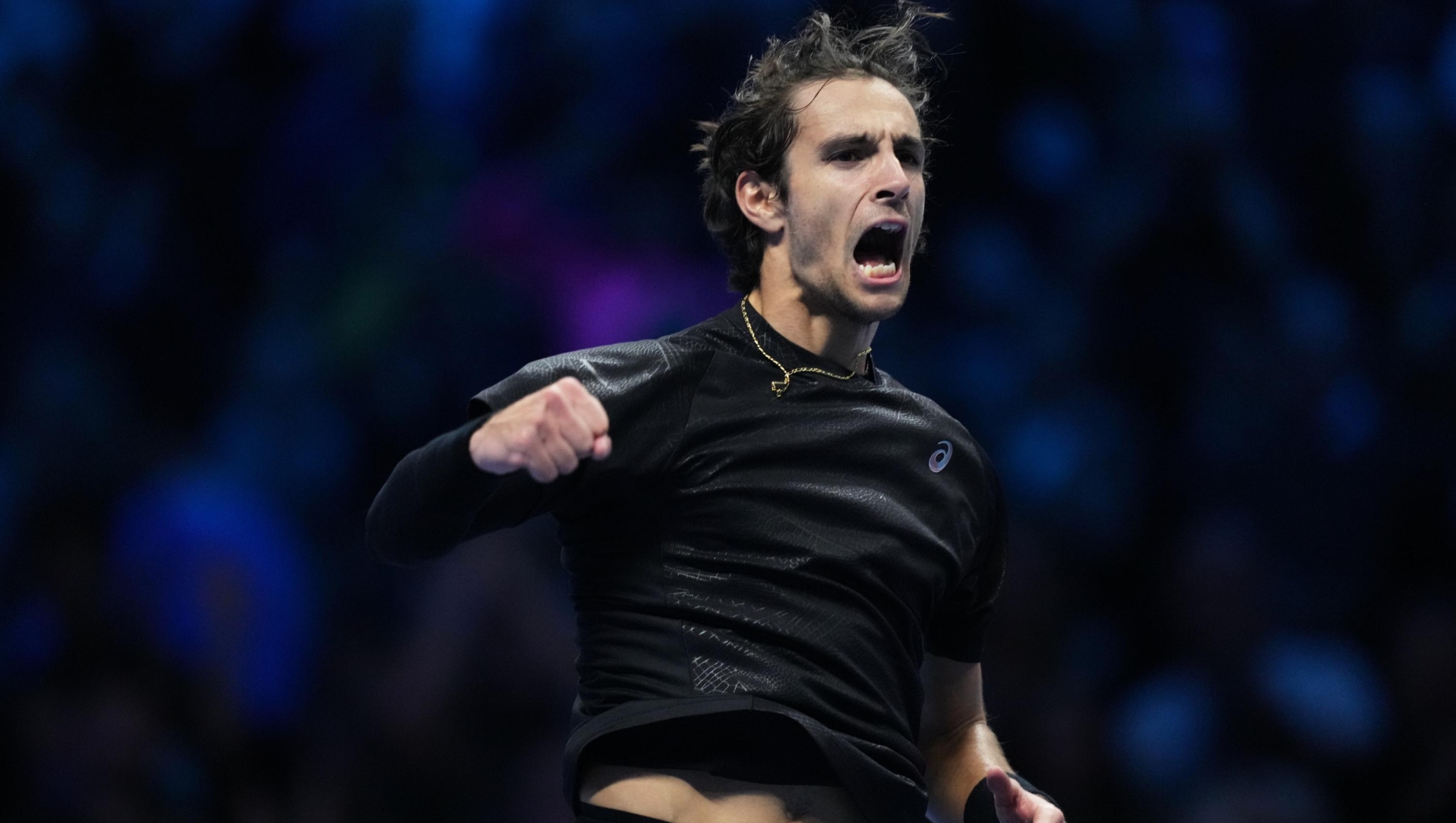 Italy's Lorenzo Musetti celebrates after winning against Australia's Alex de Minaur during their tennis match of the ATP World Tour Finals, in Turin, Italy, Tuesday, Nov. 11, 2025. (AP Photo/Antonio Calanni)
