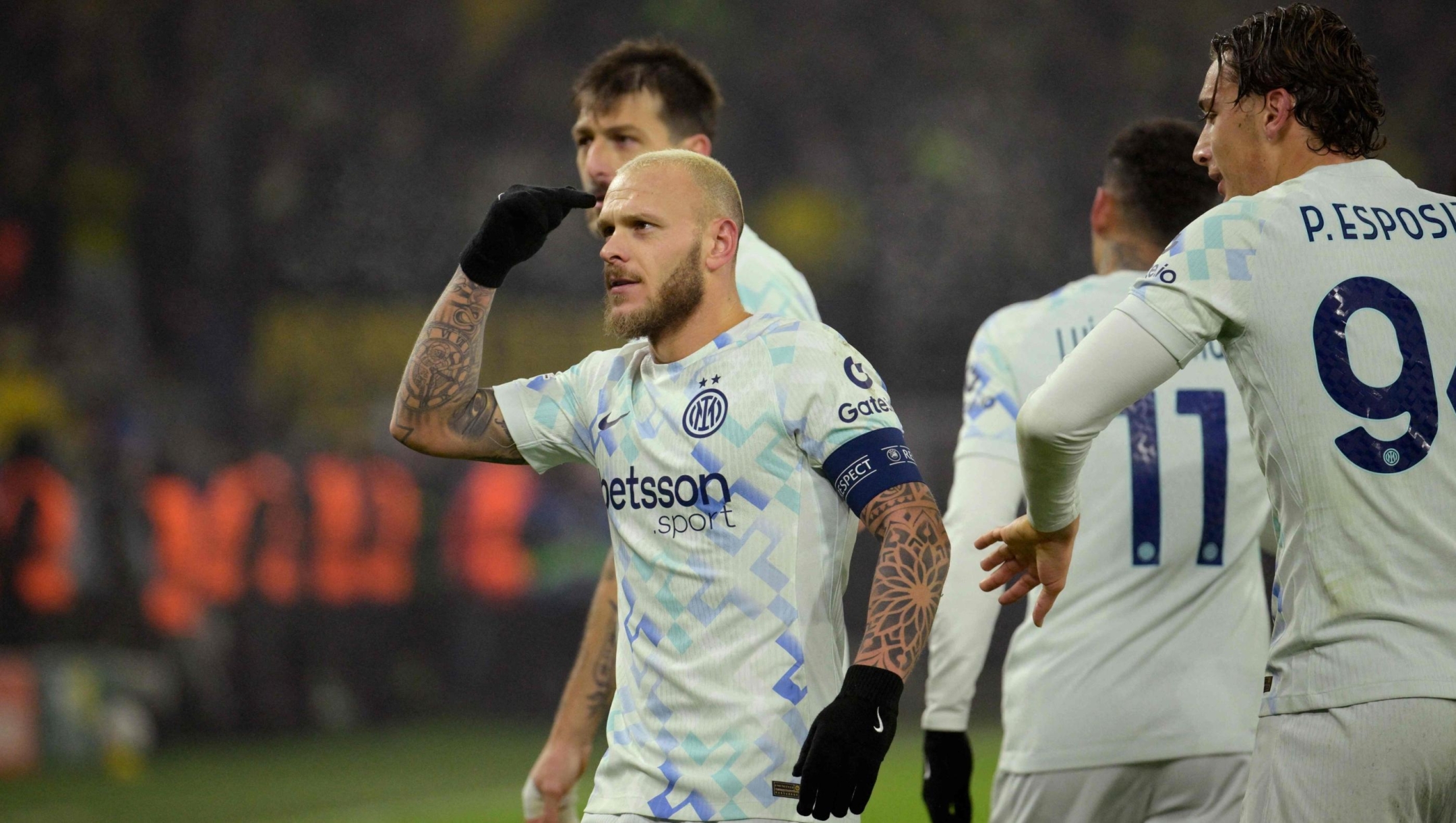 Inter Milan's Italian defender #32 Federico Dimarco (L) celebrates with team mates after scoring the opening goal 0-1 during the UEFA Champions League league phase - day 8 football match between BVB Borussia Dortmund and Inter Milan in Dortmund, western Germany, on January 28, 2026. (Photo by Sascha Schuermann / AFP)