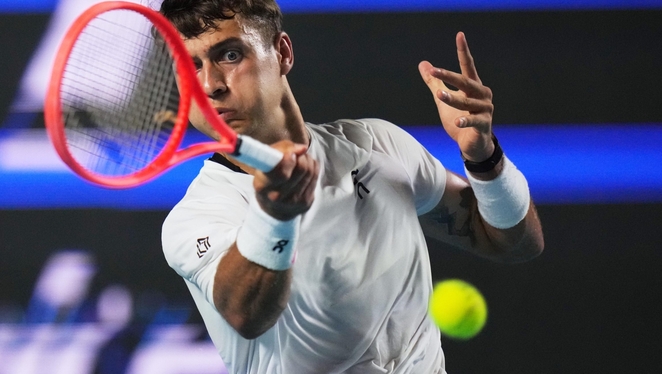 Flavio Cobolli of Italy plays a return to Frances Tiafoe of the U.S. during the singles final match at the Mexican Open tennis championship in Acapulco, Mexico, Saturday, Feb. 28, 2026. (AP Photo/Eduardo Verdugo)
