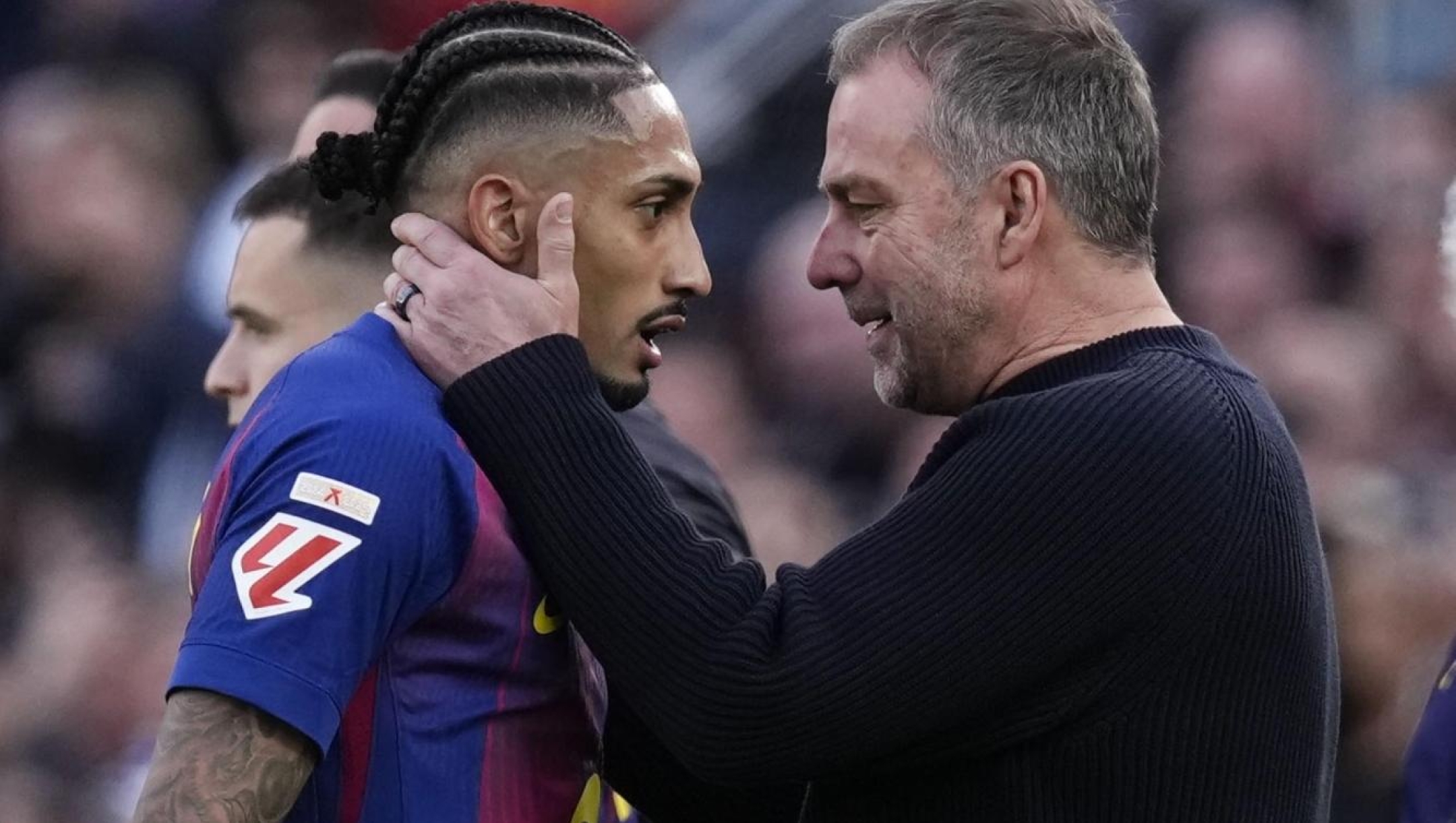 epa12822043 FC Barcelona coach Hansi Flick (R) embraces Raphinha during the Spanish LaLiga soccer match between FC Barcelona and Sevilla FC, in Barcelona, Spain, 15 March 2026.  EPA/Enric Fontcuberta