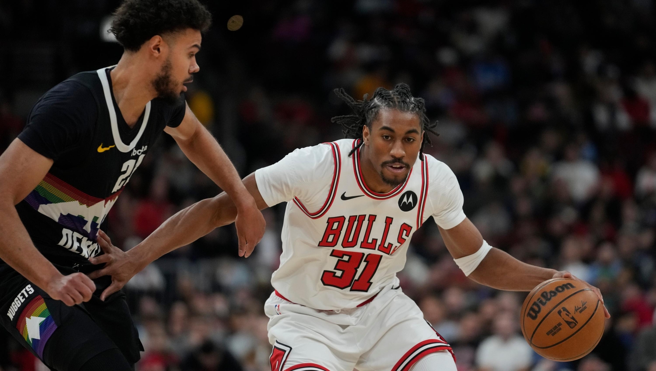 Denver Nuggets forward Spencer Jones (21), left, guards Chicago Bulls guard Jaden Ivey (31) during the first half of an NBA basketball game Saturday, Feb. 7, 2026, in Chicago. (AP Photo/Erin Hooley)