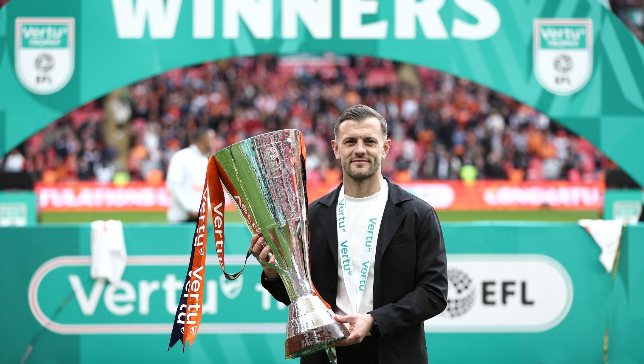  Jack Wilshere, Manager of Luton Town, poses for a photo with the Vertu Trophy after the team's victory in the Vertu Trophy Final match between Stockport County and Luton Town at Wembley Stadium on April 12, 2026 in London, England.  (Photo by James Fearn/Getty Images)