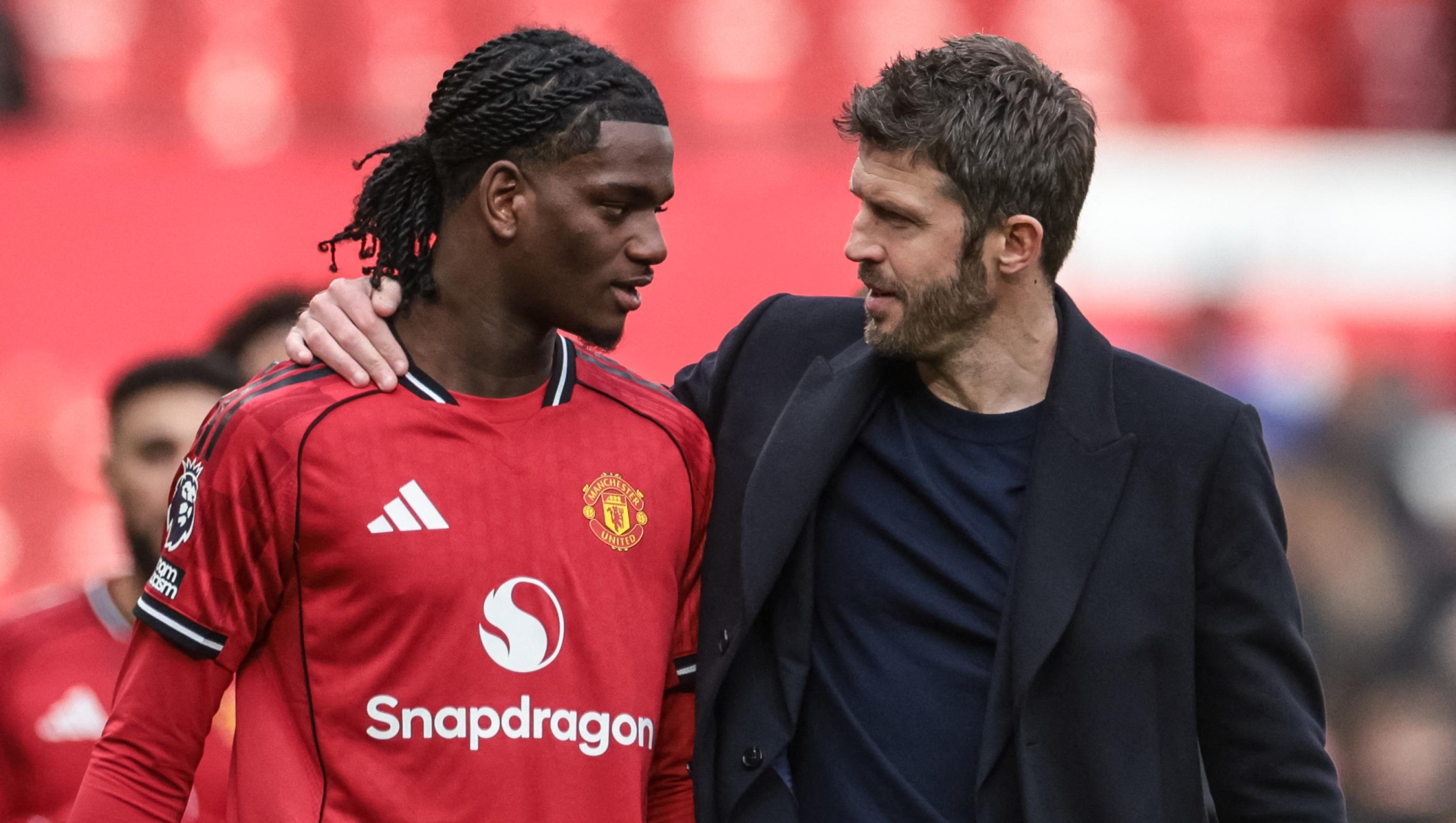 Michael Carrick, manager of Manchester United, speaks with Ayden Heaven of Manchester United during the Premier League match between Manchester United and Crystal Palace at Old Trafford in Manchester, United Kingdom, on March 1, 2026. (Photo by Mark Cosgrove/News Images/NurPhoto) (Photo by Mark Cosgrove / NurPhoto via AFP)
