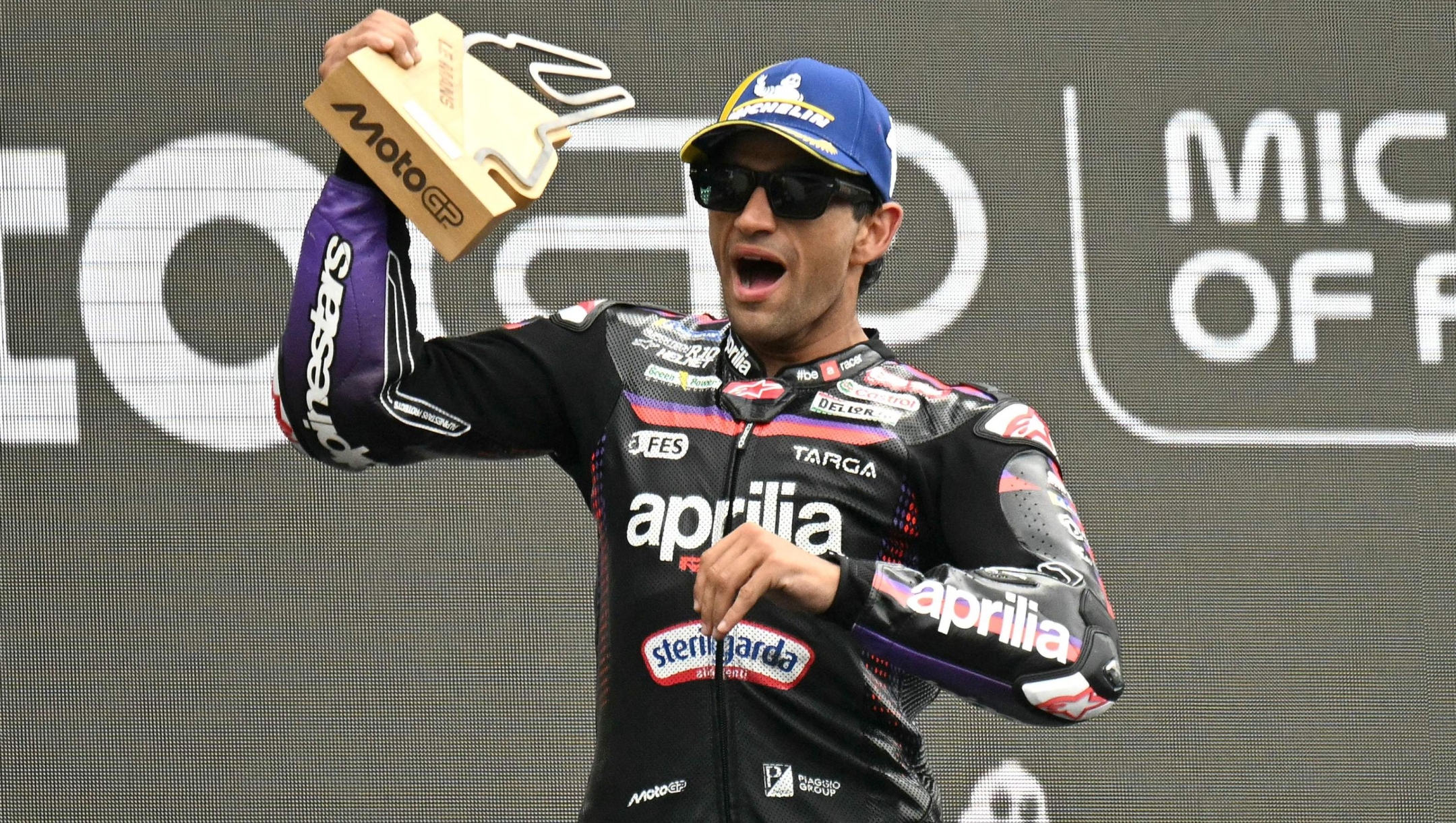 TOPSHOT - Aprilia Racing's Spanish rider Jorge Martin celebrates his victory on the podium at the end of the Moto GP Grand Prix of France at Le Mans, northwestern France, on May 10, 2026. (Photo by Loic VENANCE / AFP)