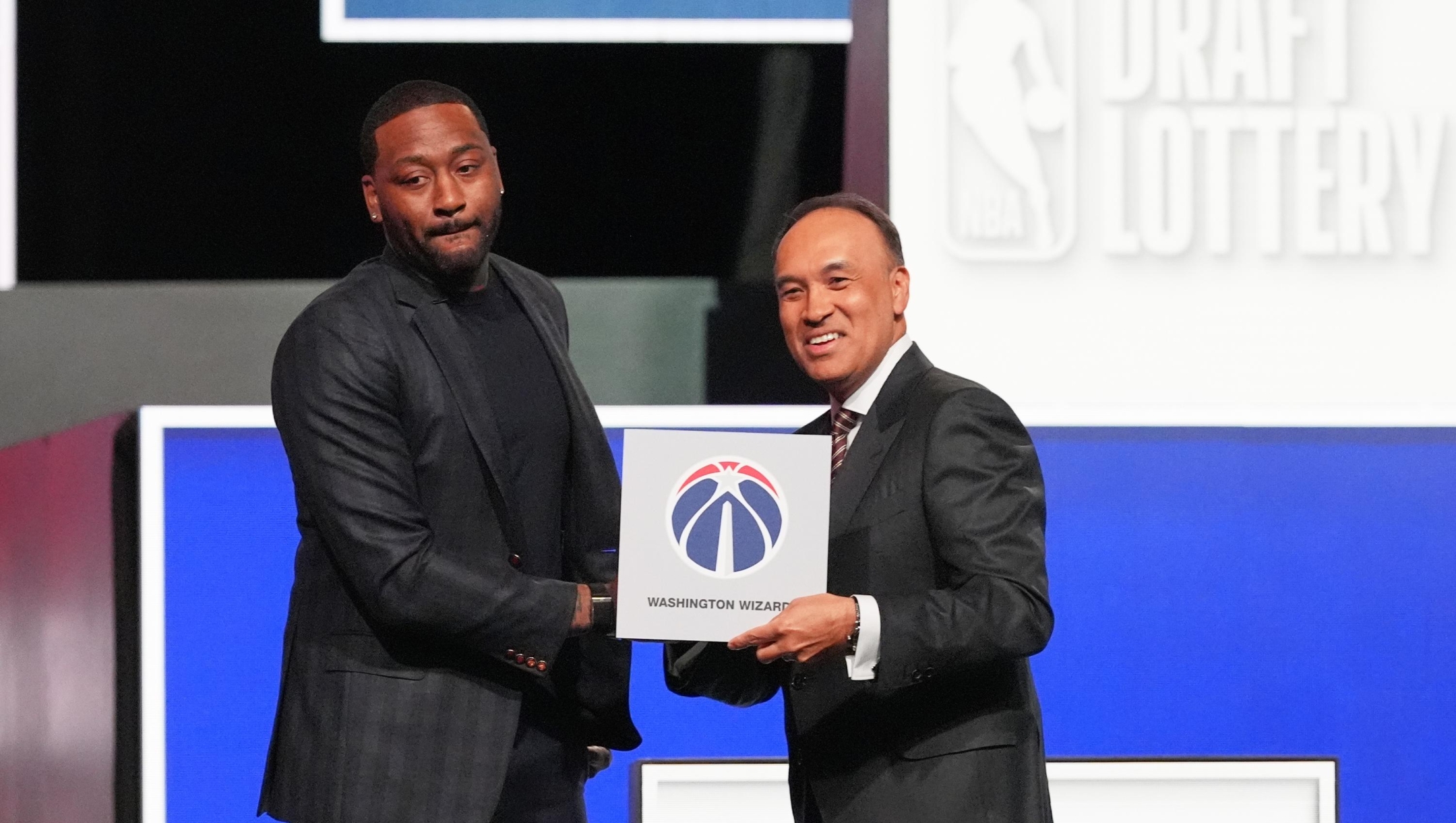 Washington Wizards' John Wall, left, and NBA Deputy Commissioner Mark Tatum, pose for photos after Tatum announced that the Wizards had won the first pick in the NBA basketball draft lottery in Chicago, Sunday, May 10, 2026. (AP Photo/Nam Y. Huh)