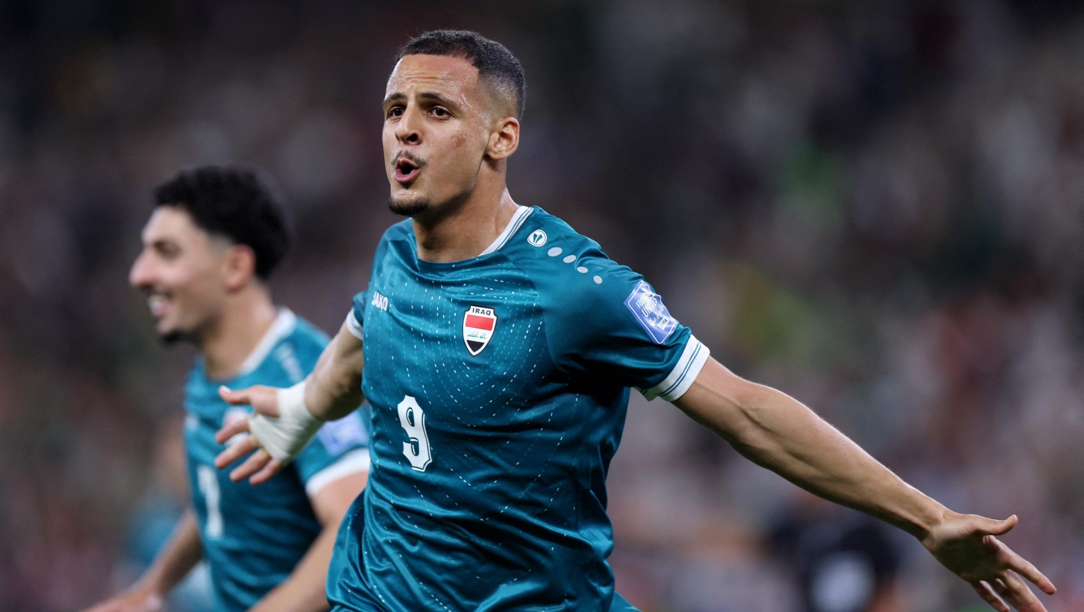 TOPSHOT - Iraq's forward #09 Ali Al-Hamadi celebrates scoring his team's first goal during the 2026 FIFA World Cup qualifiers final playoff football match between Iraq and Bolivia at the BBVA Stadium in Guadalupe, Nuevo Leon state, Mexico, on March 31, 2026. (Photo by Julio Cesar AGUILAR / AFP)