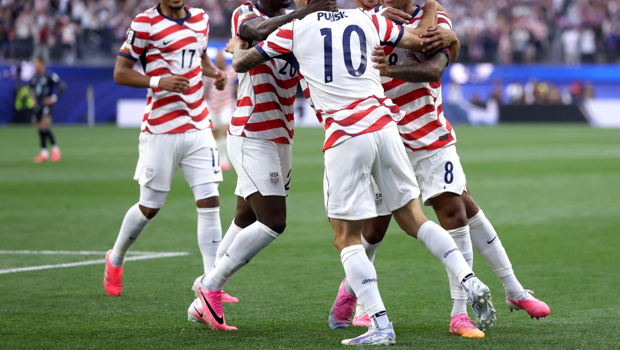  Christian Pulisic #10 and Weston McKennie #8 of the United States celebrate their side's first goal, an own goal by Damian Bobadilla #16 of Paraguay (not pictured), during the FIFA World Cup 2026 Group D match between USA and Paraguay at Los Angeles Stadium on June 12, 2026 in Los Angeles, California.   Dean Mouhtaropoulos/Getty Images/AFP (Photo by Dean Mouhtaropoulos / GETTY IMAGES NORTH AMERICA / Getty Images via AFP)