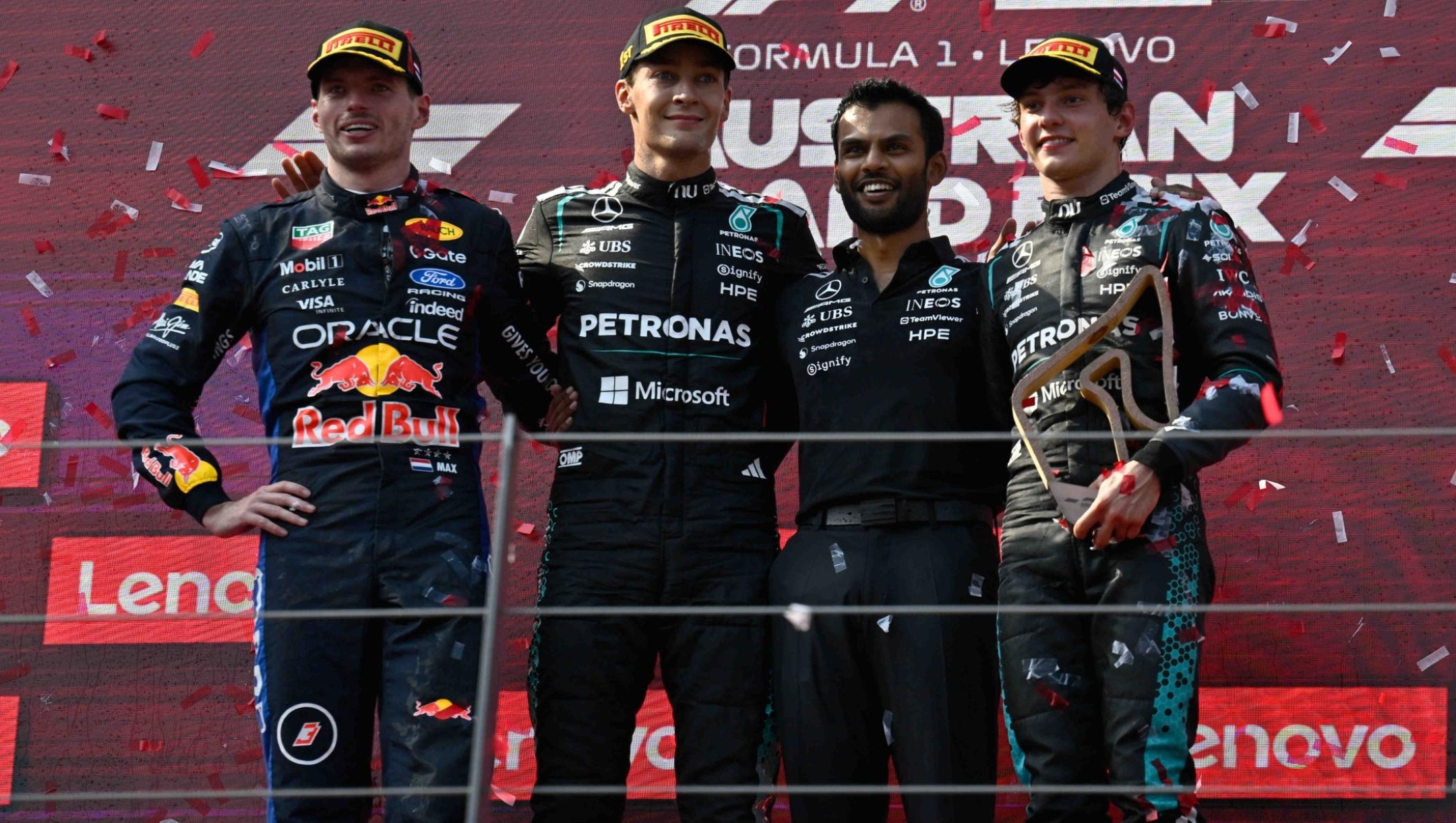 Race winner Mercedes driver George Russell of Britain, second left,, stands on the podium with second placed Red Bull driver Max Verstappen of the Netherlands, left, and third placed Mercedes driver Andrea Kimi Antonelli of Italy, right, after the Austrian F1 Grand Prix, in Spielberg, Austria, Sunday, June 28, 2026. (AP Photo/Denes Erdos)