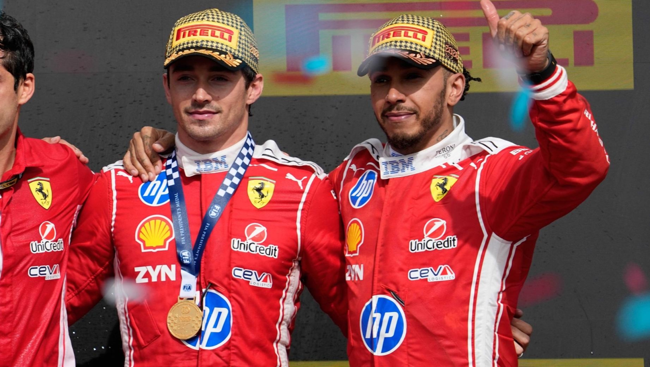 Race winner Ferrari driver Charles Leclerc of Monaco, third left, poses on the podium with second placed Mercedes driver George Russell of Britain, left, and third placed Ferrari driver Lewis Hamilton of Britain, right, after the British F1 Grand Prix, in Silverstone, England, Sunday, July 5, 2026. (AP Photo/Darko Bandic)