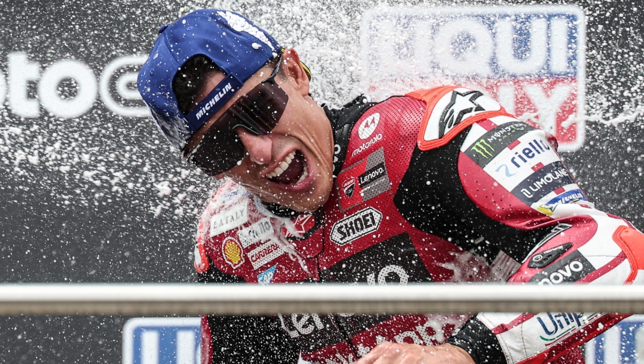 epa13106908 Ducati Lenovo Team rider Marc Marquez of Spain celebrates on the podium after winning the MotoGP race of the motorcycling Grand Prix of Germany at the Sachsenring racing circuit in Hohenstein-Ernstthal, Germany, 12 July 2026.  EPA/FILIP SINGER
